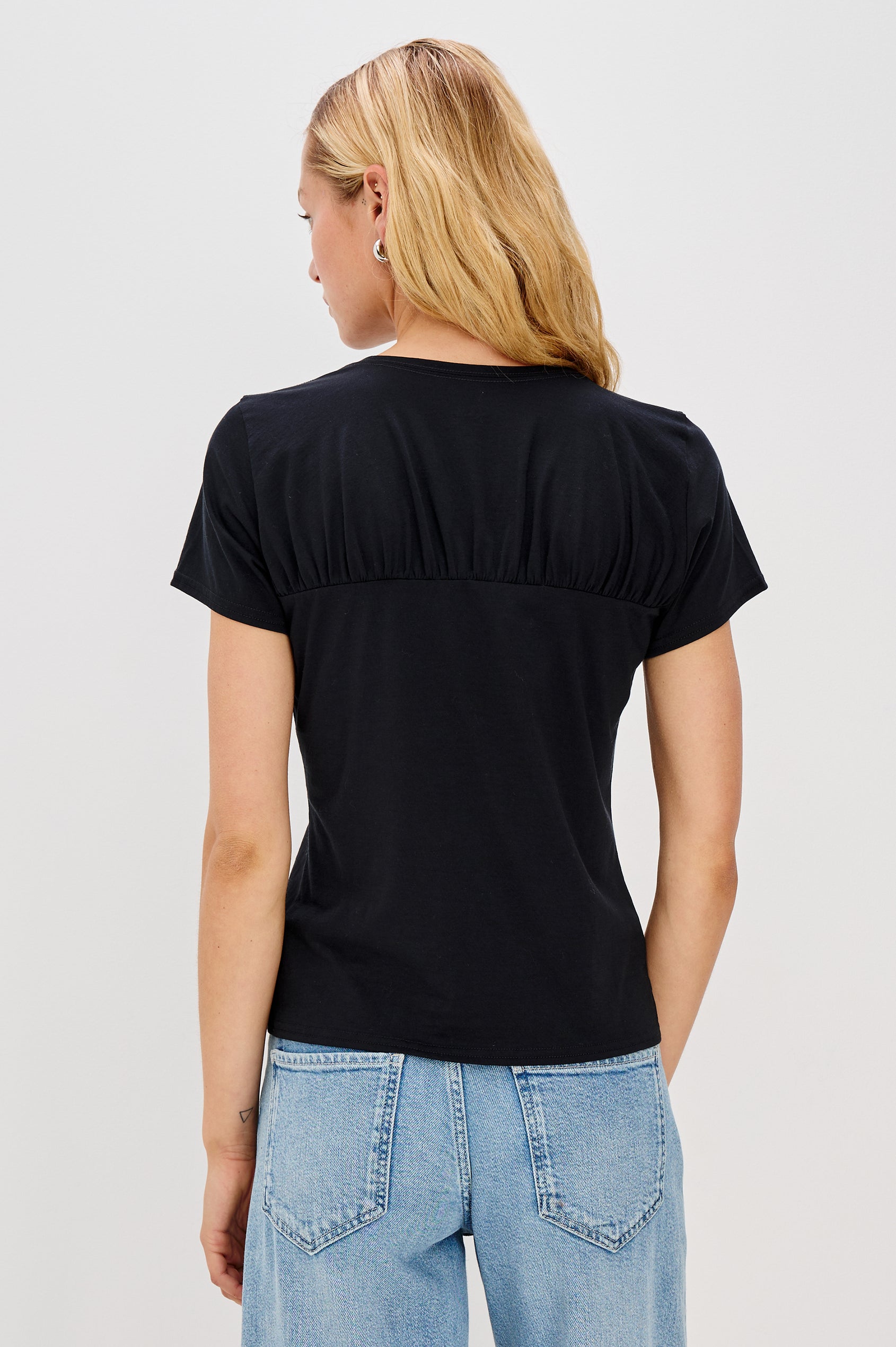 Janis crewneck short sleeve t-shirt with sweetheart neckline hem details in Black colorway - back view on model