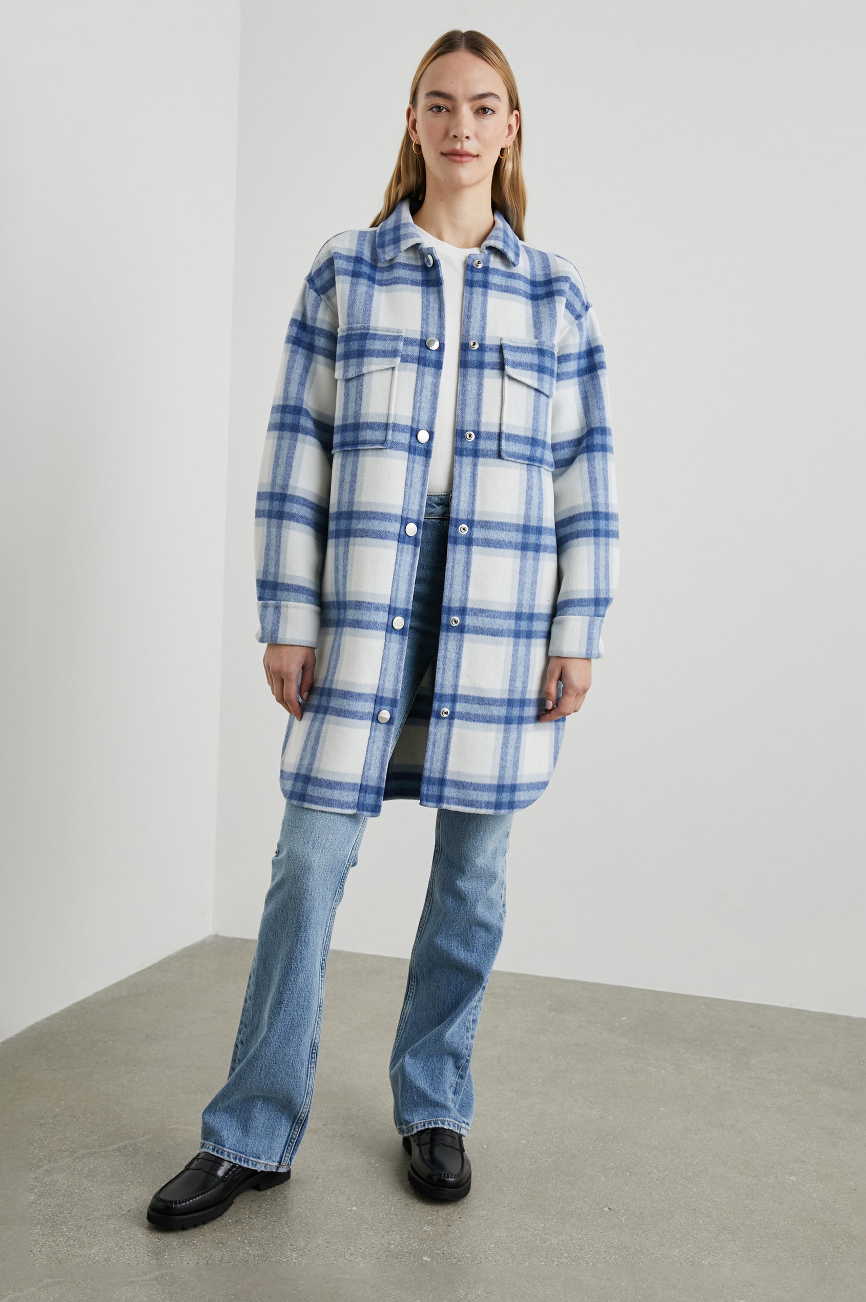 Jaro Mid-Thigh Length Coat with Snap Closure, Snap Cuffs, Two Chest Flap Pockets, Two Front Pockets and Side Hem Slits in Ivory Bay Colorway, an Ivory and Blue Plaid - Front Full Body View Featured on Model 