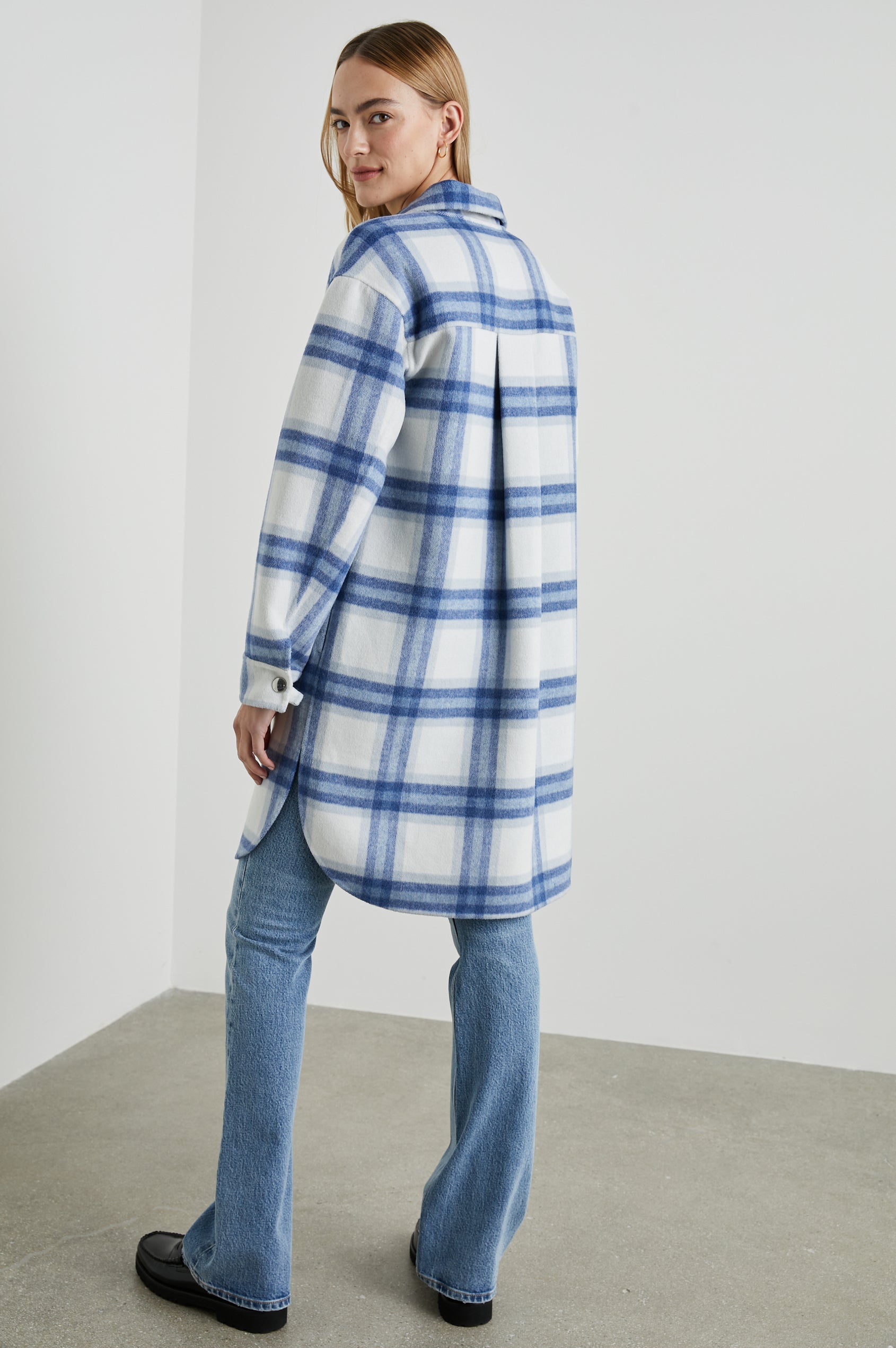 Jaro Mid-Thigh Length Coat with Snap Closure, Snap Cuffs, Two Chest Flap Pockets, Two Front Pockets and Side Hem Slits in Ivory Bay Colorway, an Ivory and Blue Plaid - Back Full Body View Featured on Model 