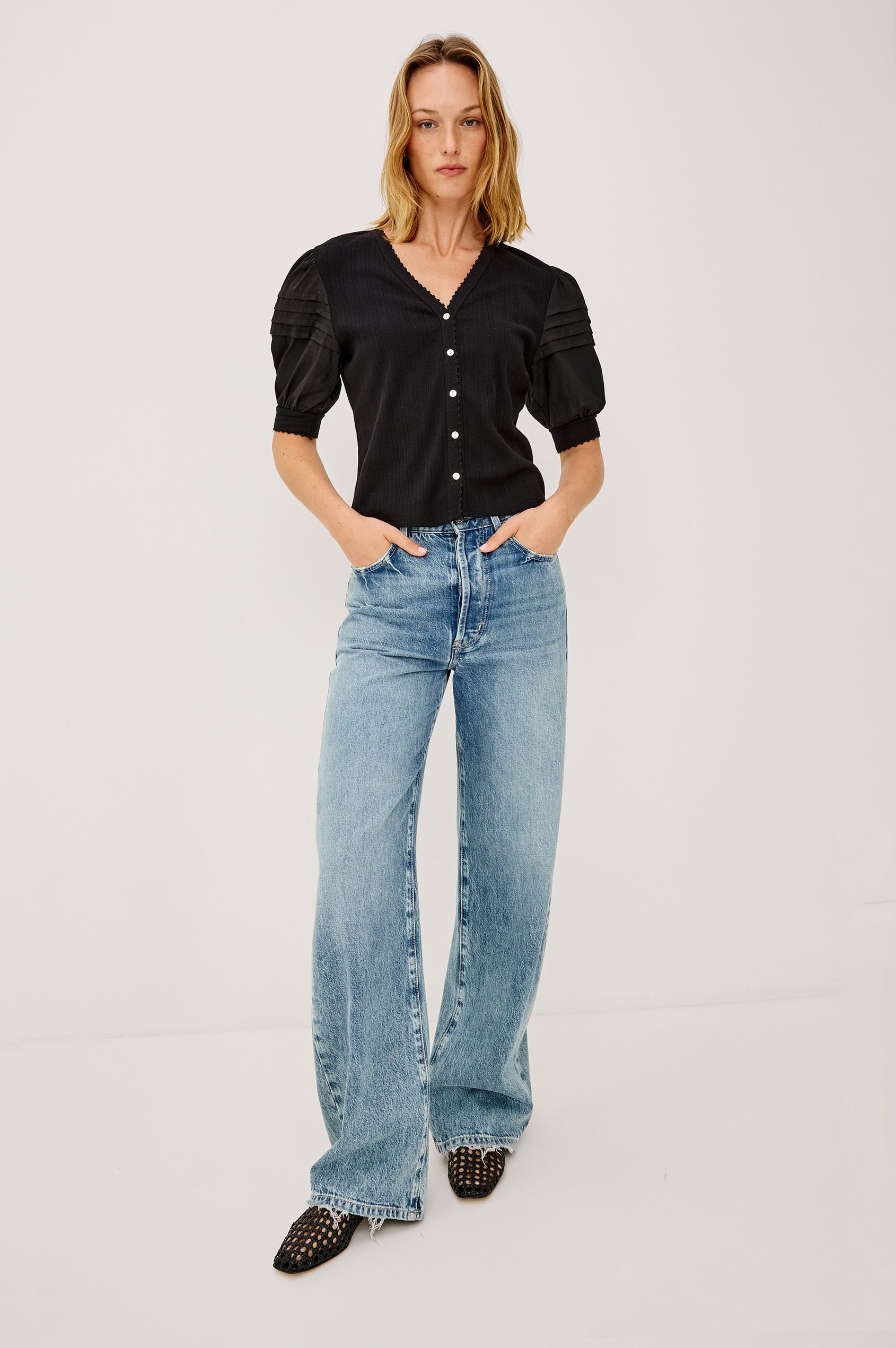 Jessie Top in Pointelle With V-Neckline, Front Buttons, Short Cuffed Puff Sleeves, and Relaxed Fit in White Colorway - Full Body Front View Featured on Model