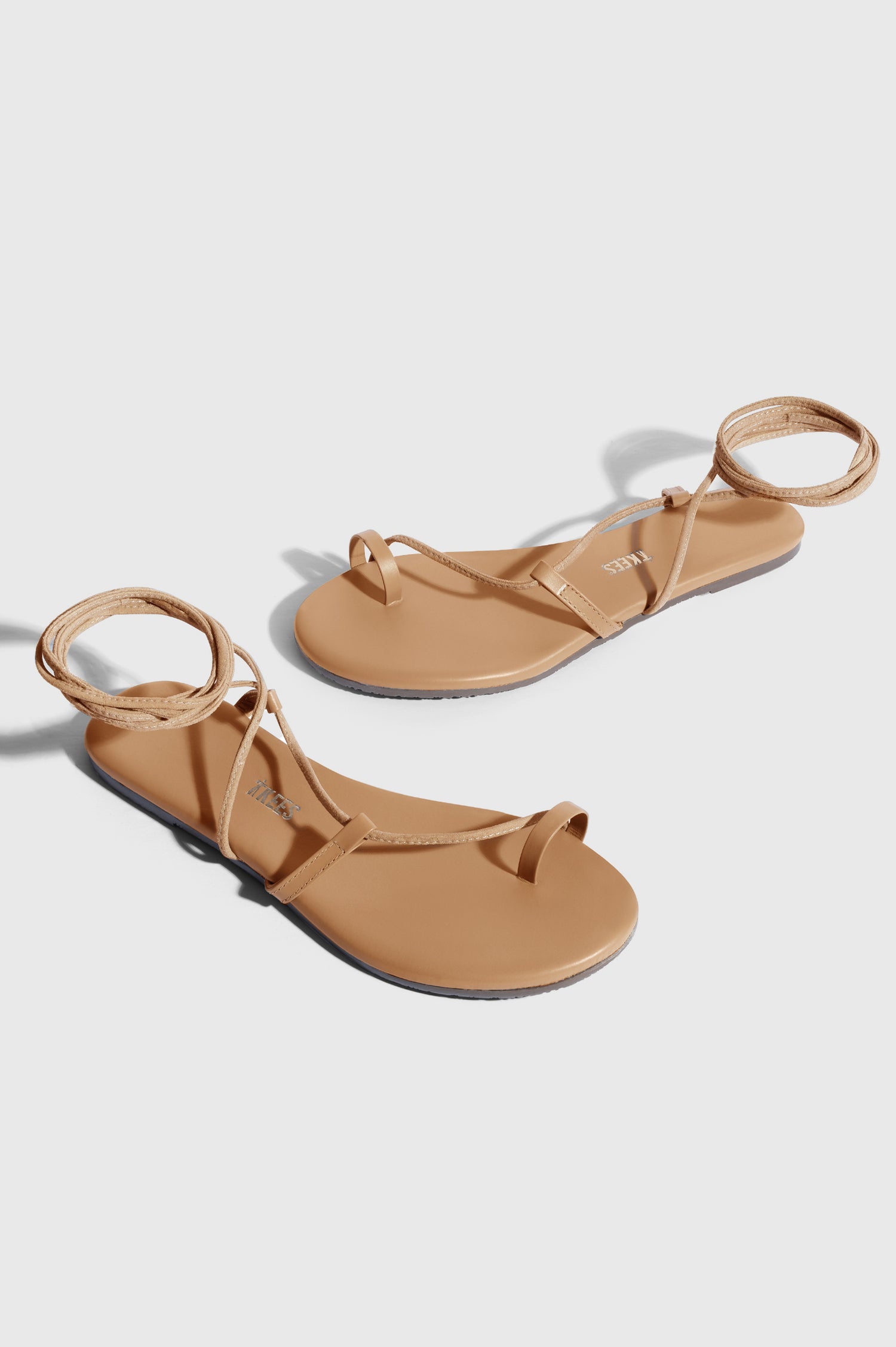 Jo leather sandal with toe loop and crossing straps that wrap the ankle in Hazelton - cross angled view of pair of shoes