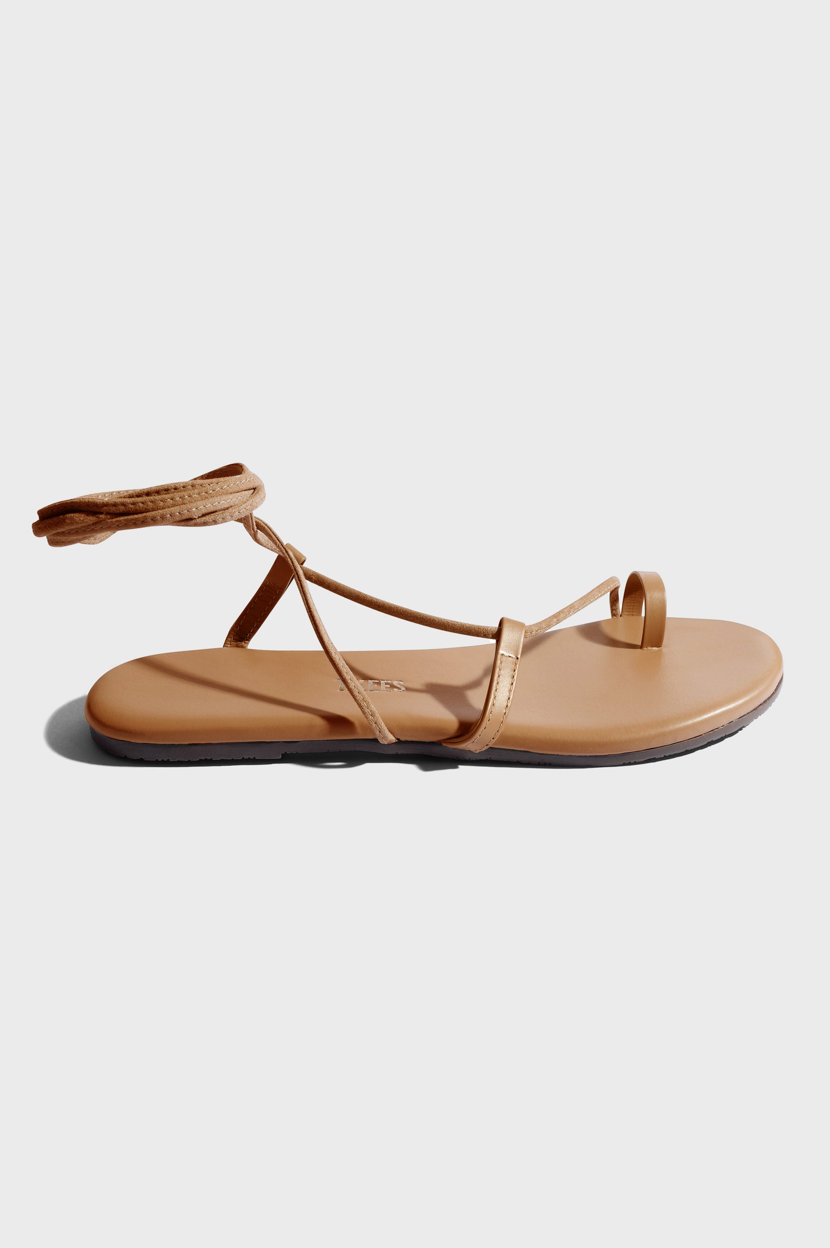 Jo leather sandal with toe loop and crossing straps that wrap the ankle in Hazelton - side view of single shoe