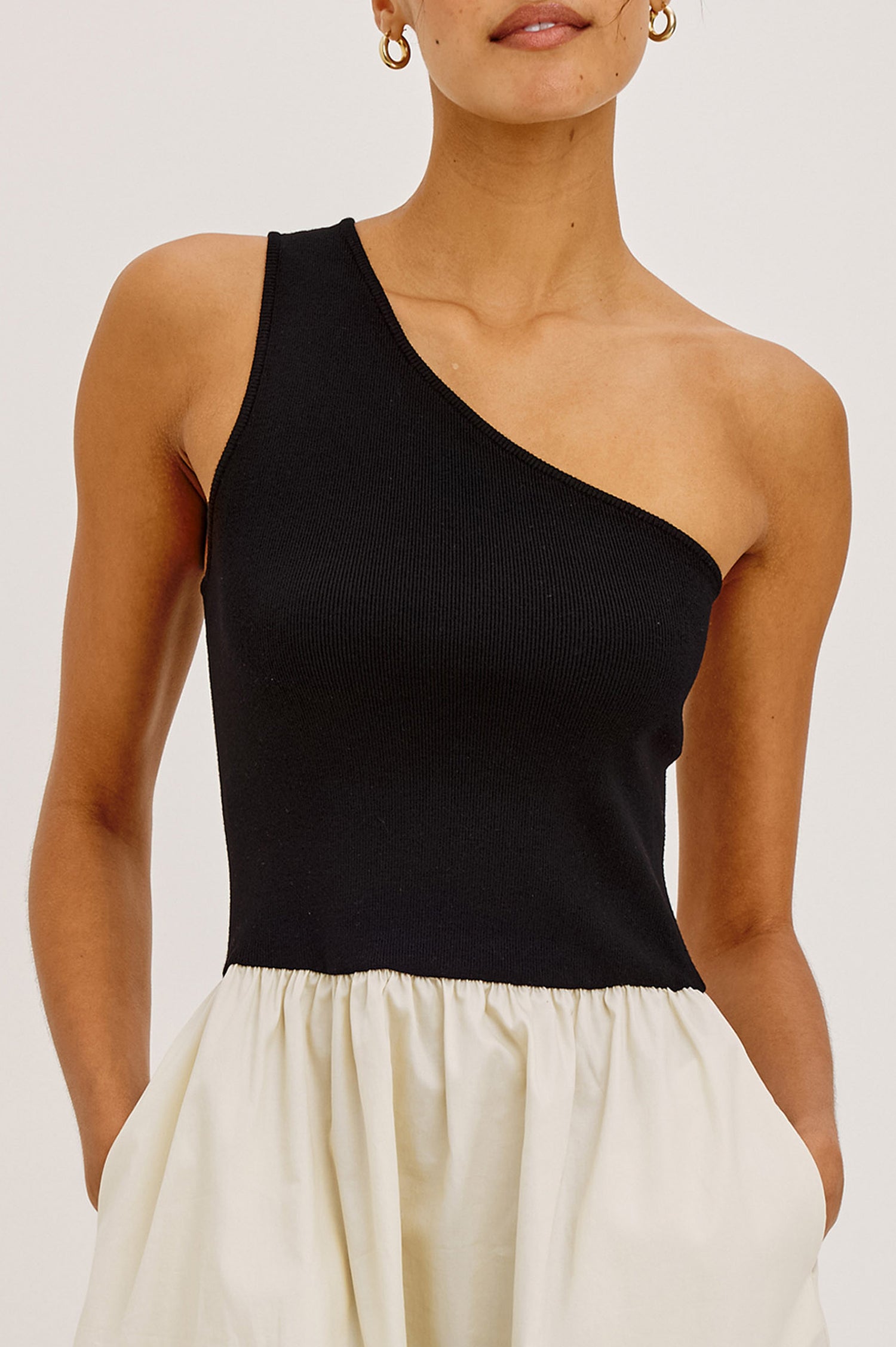 Joanne Mini Dress With One-Shoulder Neckline, Soft Jersey Bodice, Contrast Dropwaist Cotton Poplin Skirt, and Side Pockets in Black Ivory Colorway - Upper Body Front View Featured on Model