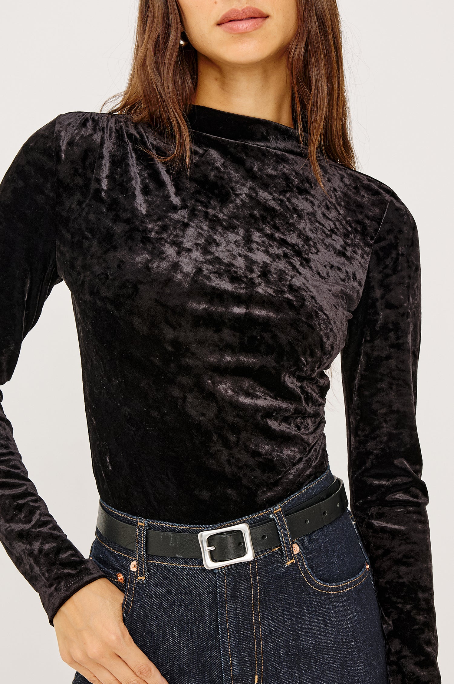 Joelle Top in Stretch Velvet With Subtle Mock Neck, Fitted Silhouette, Side Shirring, and Long Sleeves in Black Colorway - Upper Body Front Close Up View Featued on Model