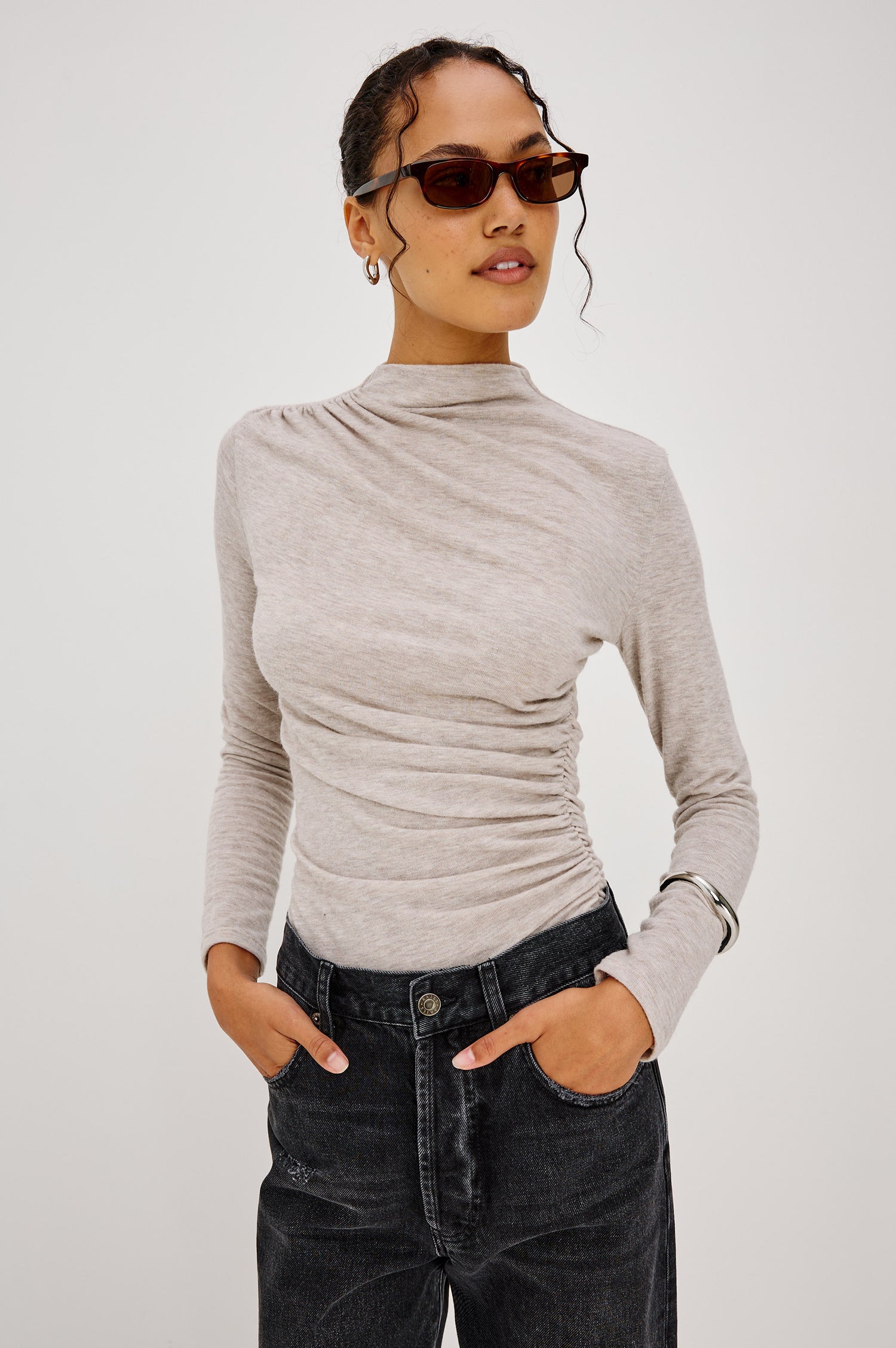 Joelle Top Fitted in Jersey With High Funnel Neckl, Long Sleeves, and Asymmetric Shoulder Shirring in Heather Oatmeal Colorway - Upper Body Front View Featured on Model