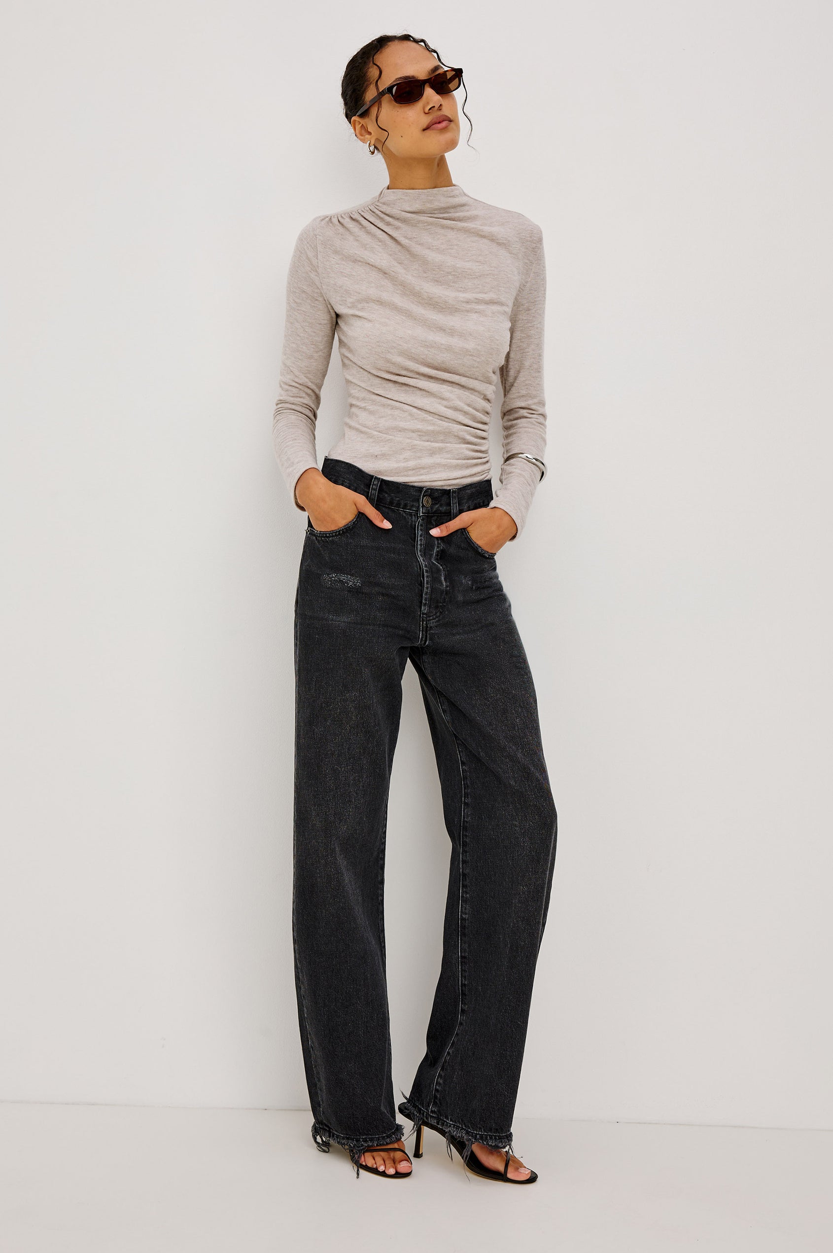 Joelle Top Fitted in Jersey With High Funnel Neckl, Long Sleeves, and Asymmetric Shoulder Shirring in Heather Oatmeal Colorway - Full Body Front View Featured on Model