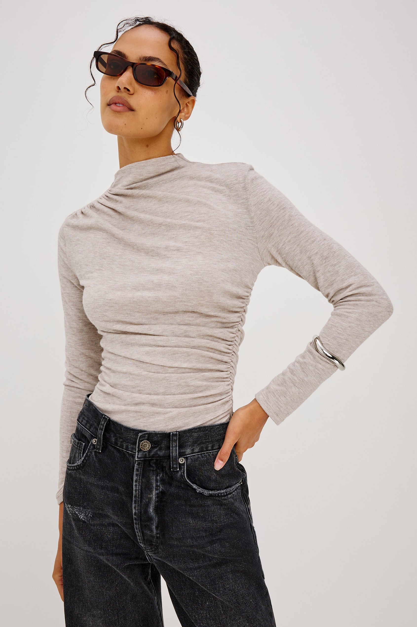 Joelle Top Fitted in Jersey With High Funnel Neckl, Long Sleeves, and Asymmetric Shoulder Shirring in Heather Oatmeal Colorway - Upper Body Front View Featured on Model