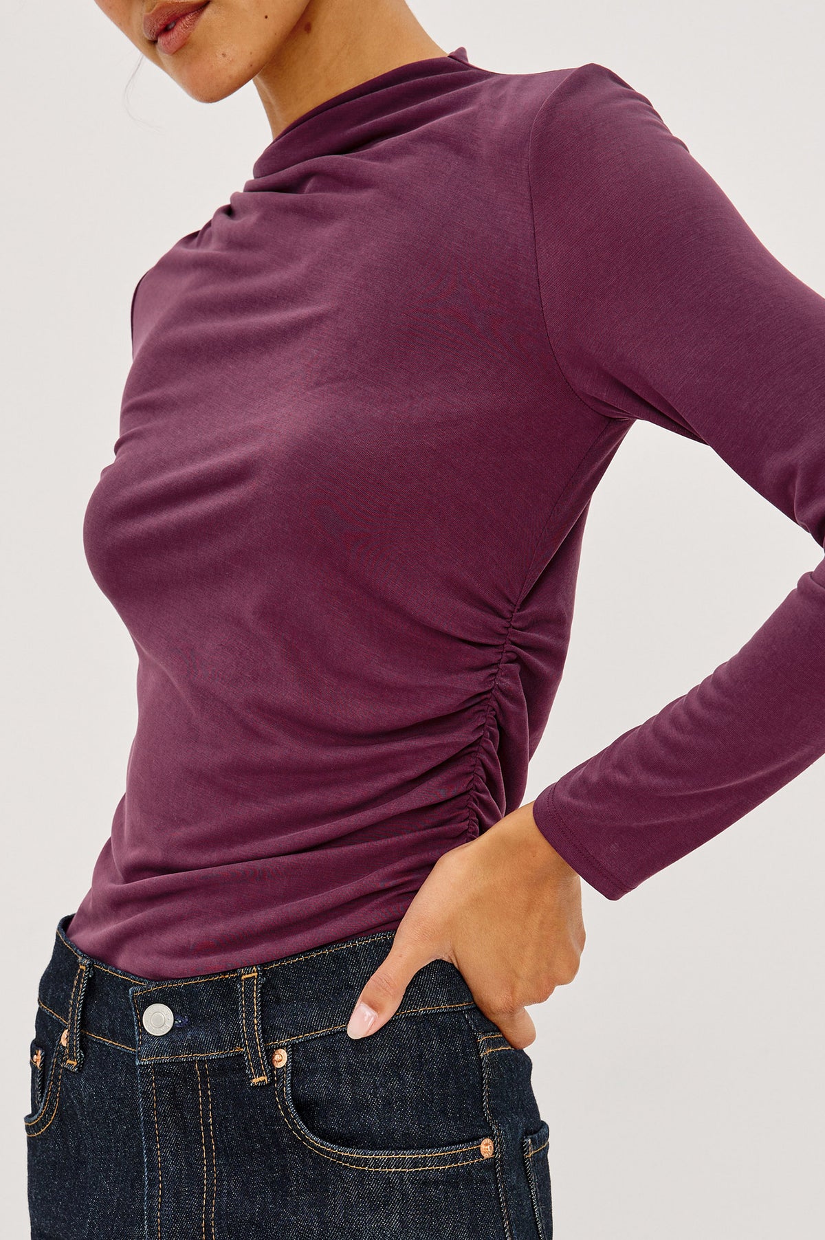 Joelle Top in Brushed Jersey With Draped Mock Neck, Shirring at Shoulder and Side, Long Sleeves, and Fitted Silhouette in Wine Colorway - Side Crop Detail View Featured on Model.