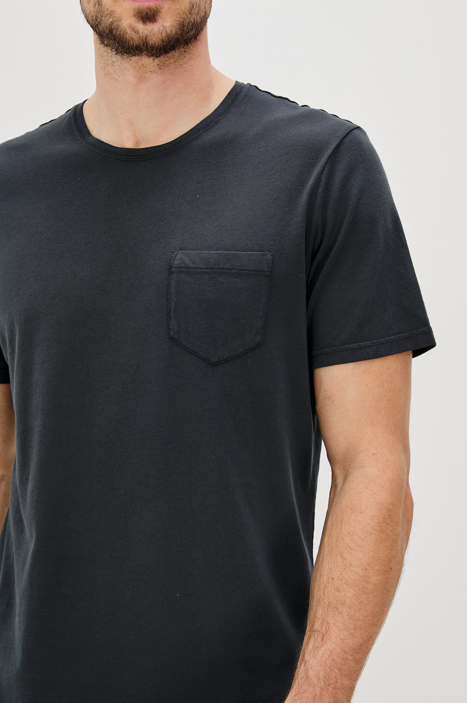 Johnny Short Sleeve T-Shirt with a Crew Neck, Chest Patch Pocket and Small Slits at the Side Hems in Carbon Colorway - Front Detail View Featured on Model