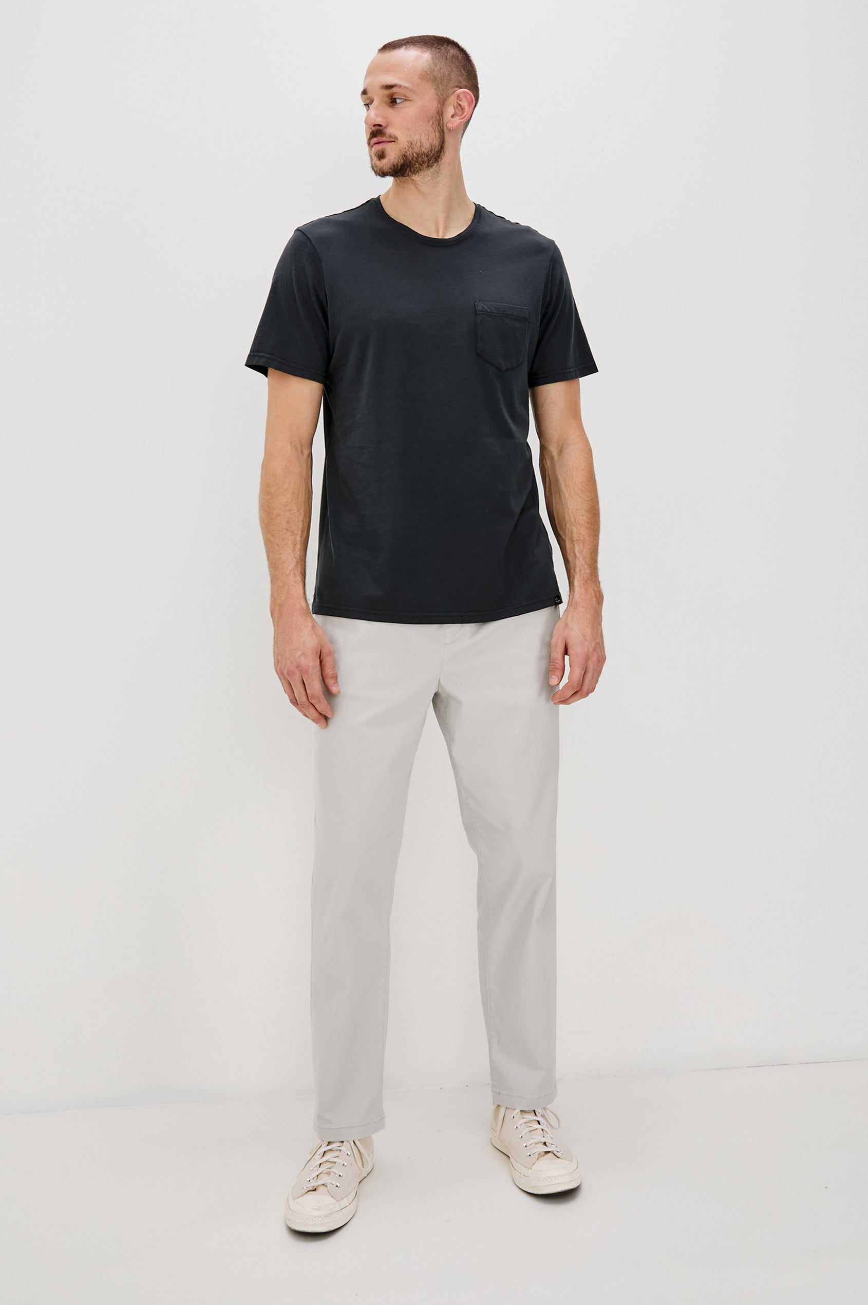 Johnny Short Sleeve T-Shirt with a Crew Neck, Chest Patch Pocket and Small Slits at the Side Hems in Carbon Colorway - Front Full Body View Featured on Model