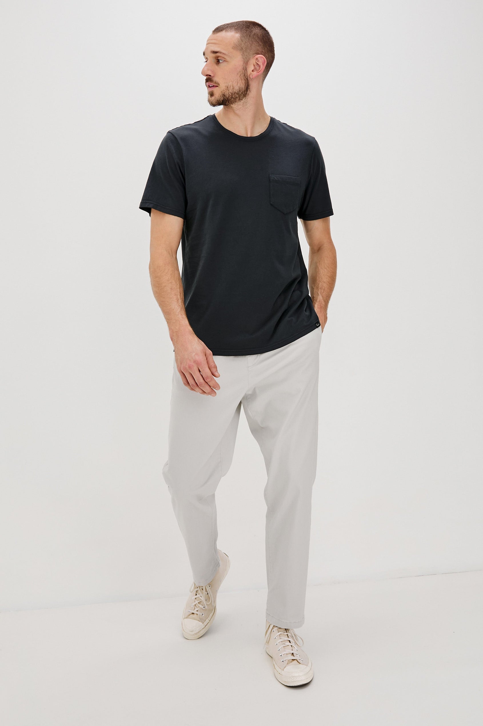 Johnny Short Sleeve T-Shirt with a Crew Neck, Chest Patch Pocket and Small Slits at the Side Hems in Carbon Colorway - Front Full Body View Featured on Model