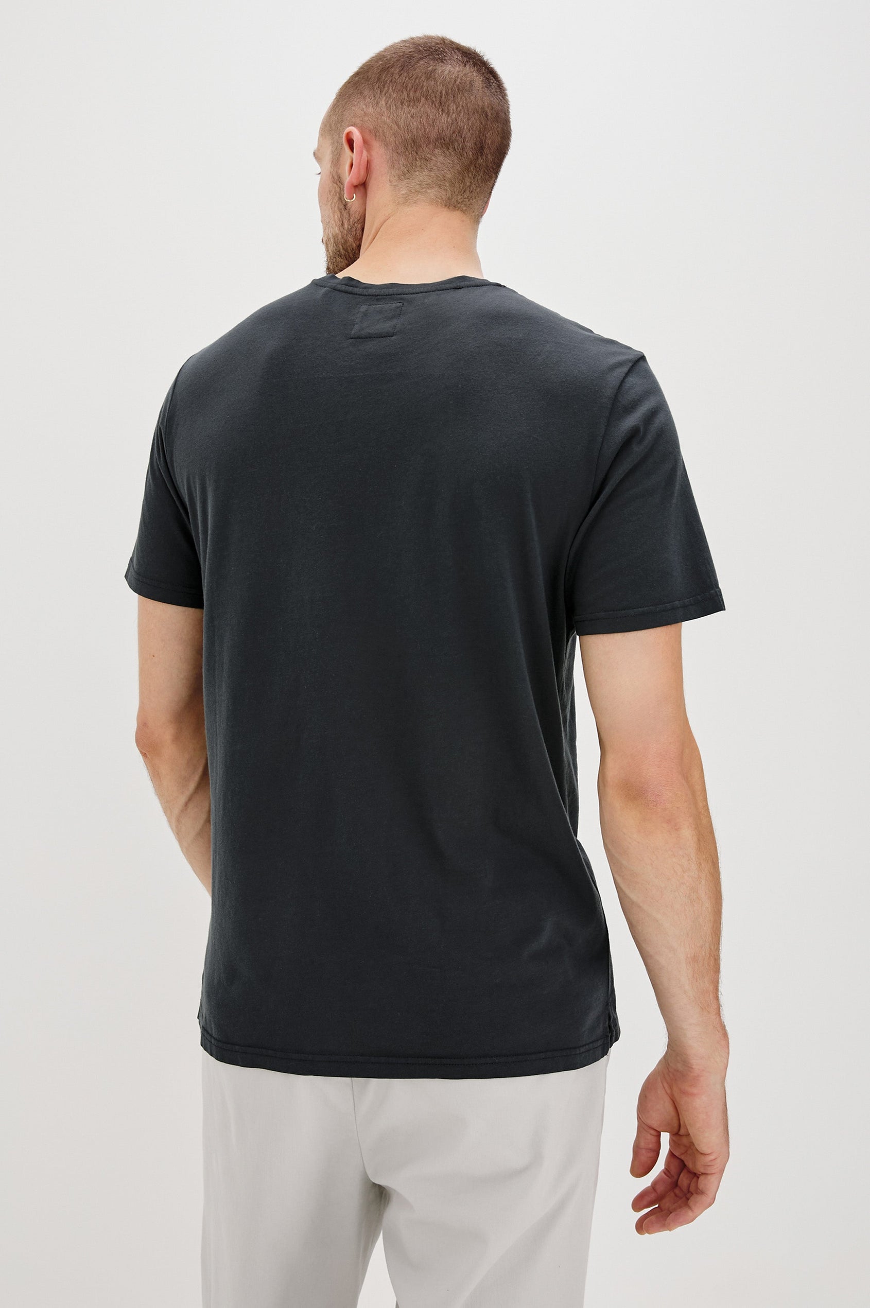 Johnny Short Sleeve T-Shirt with a Crew Neck, Chest Patch Pocket and Small Slits at the Side Hems in Carbon Colorway - Back View Featured on Model