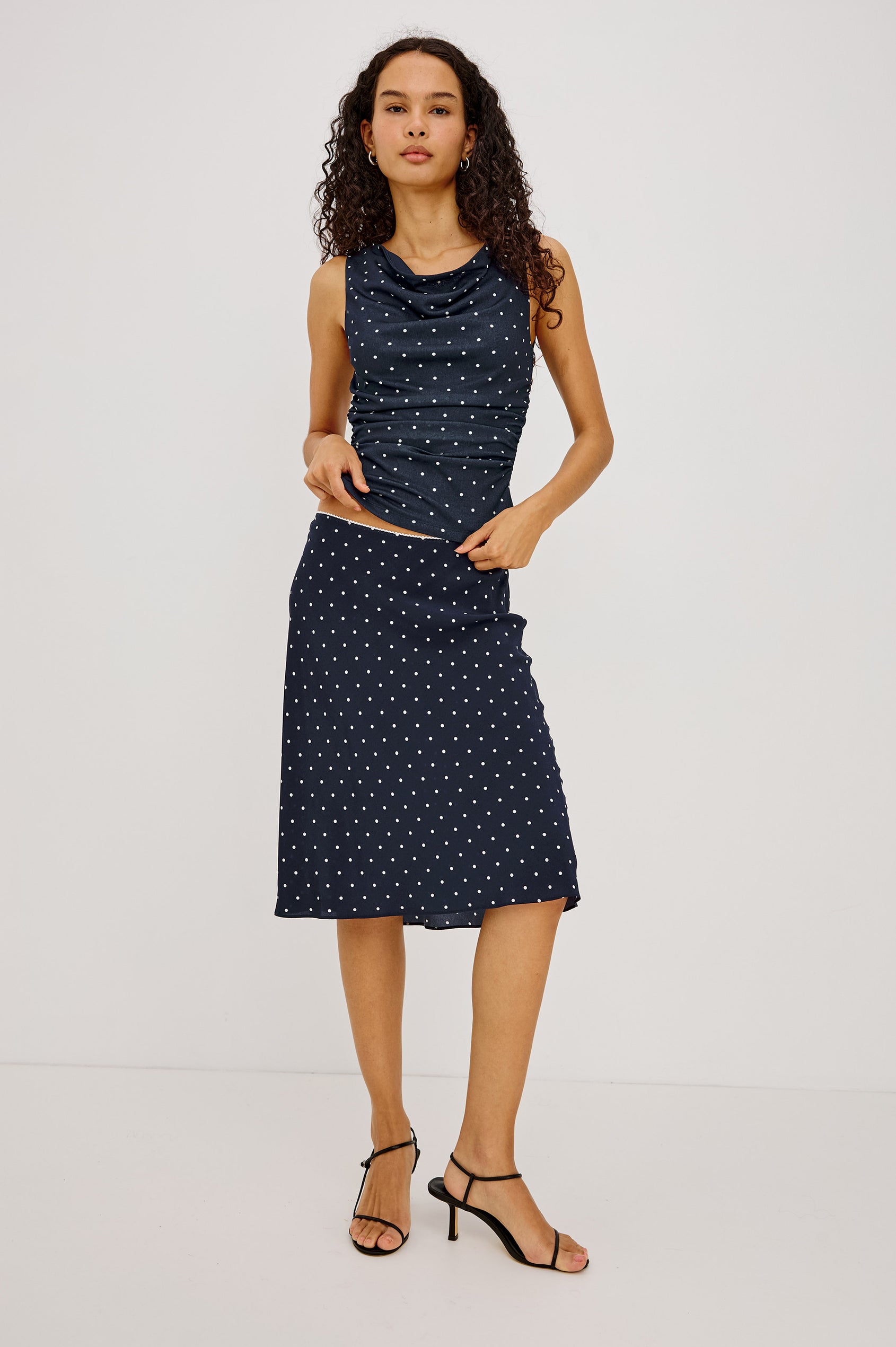 Jolene Midi Skirt in Rayon Crepe With Scalloped Elastic Waistband in Navy Polka Dots Colorway - Full Body Front View Featured on Model