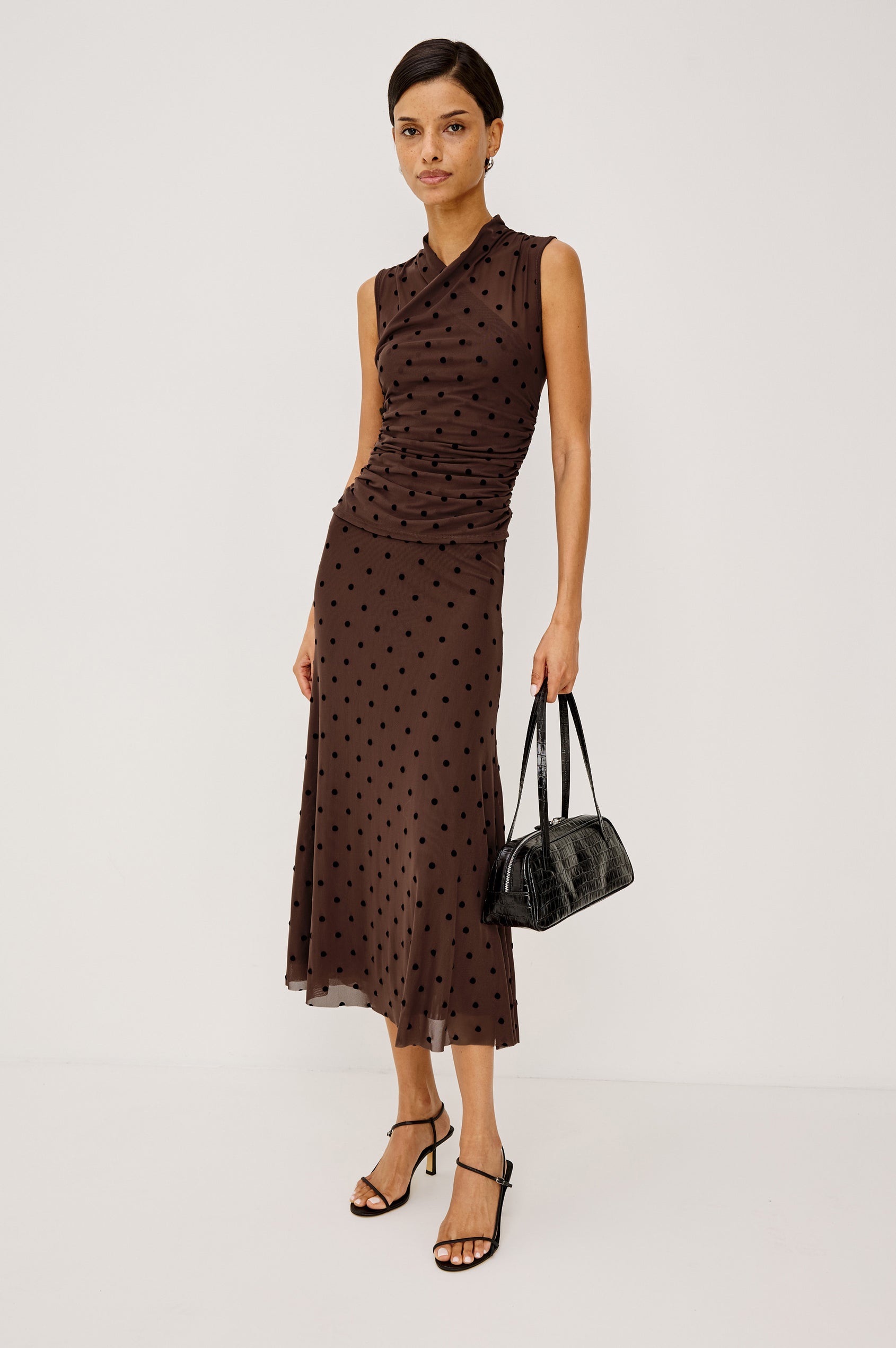 Jordan Midi Skirt in Stretch Mesh With Velvet Flocked Details, A-Line Fit, Full Lining, and Elastic Waistband in Chocolate Polka Dot Colorway - Lower Body Front View Featured on Model