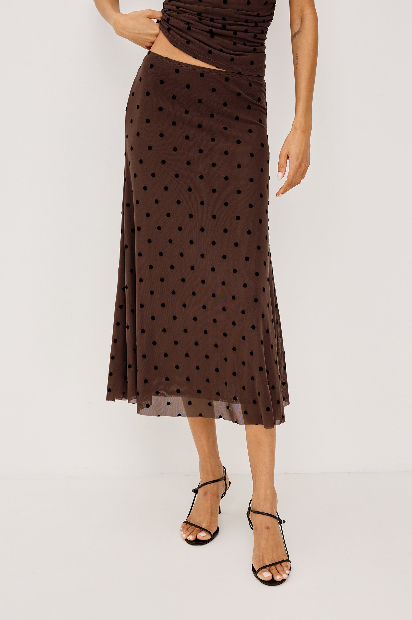 Jordan Midi Skirt in Stretch Mesh With Velvet Flocked Details, A-Line Fit, Full Lining, and Elastic Waistband in Chocolate Polka Dot Colorway - Full Body Front View Featured on Model