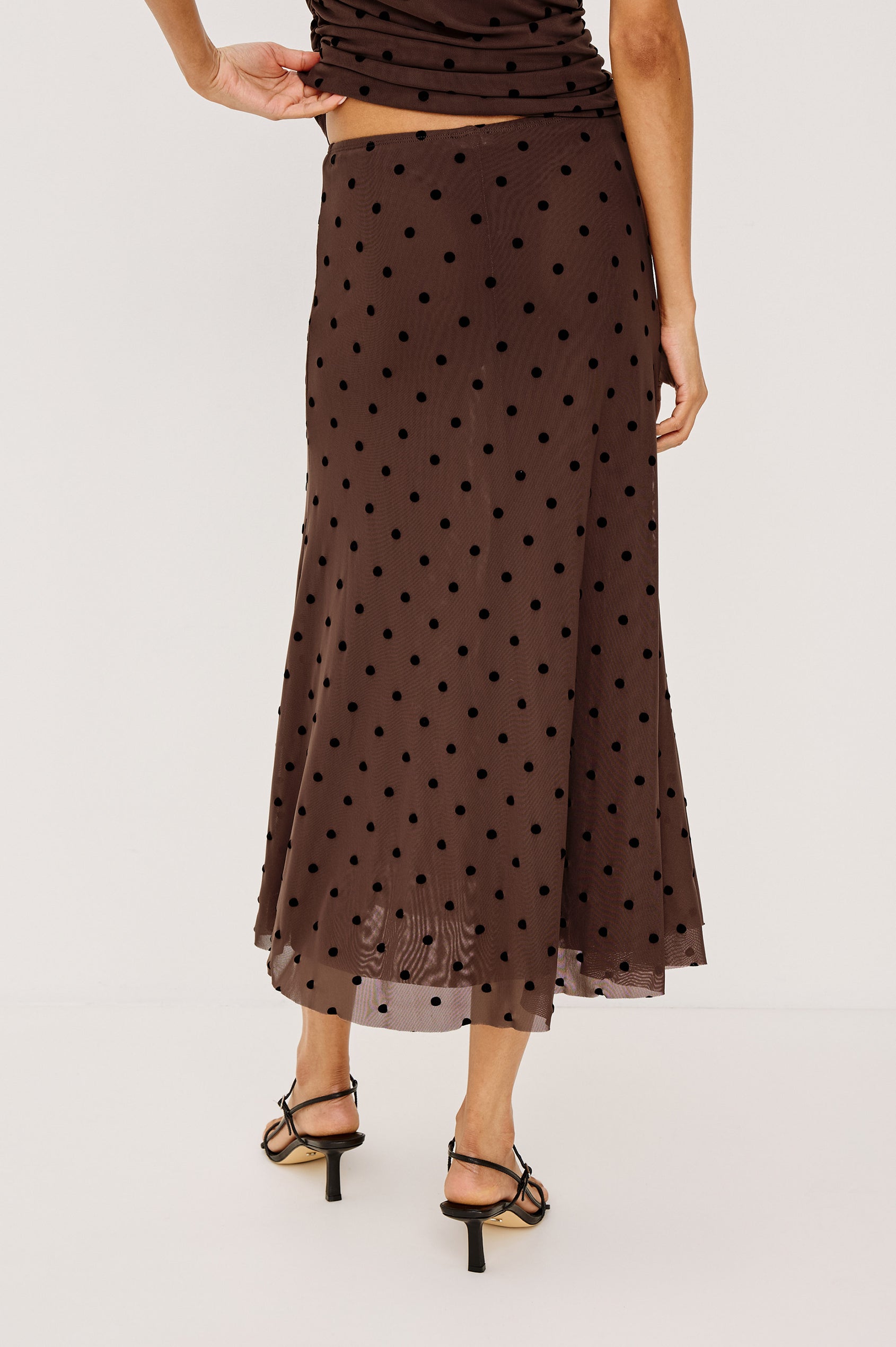 Jordan Midi Skirt in Stretch Mesh With Velvet Flocked Details, A-Line Fit, Full Lining, and Elastic Waistband in Chocolate Polka Dot Colorway - Lower Body Back View Featured on Model