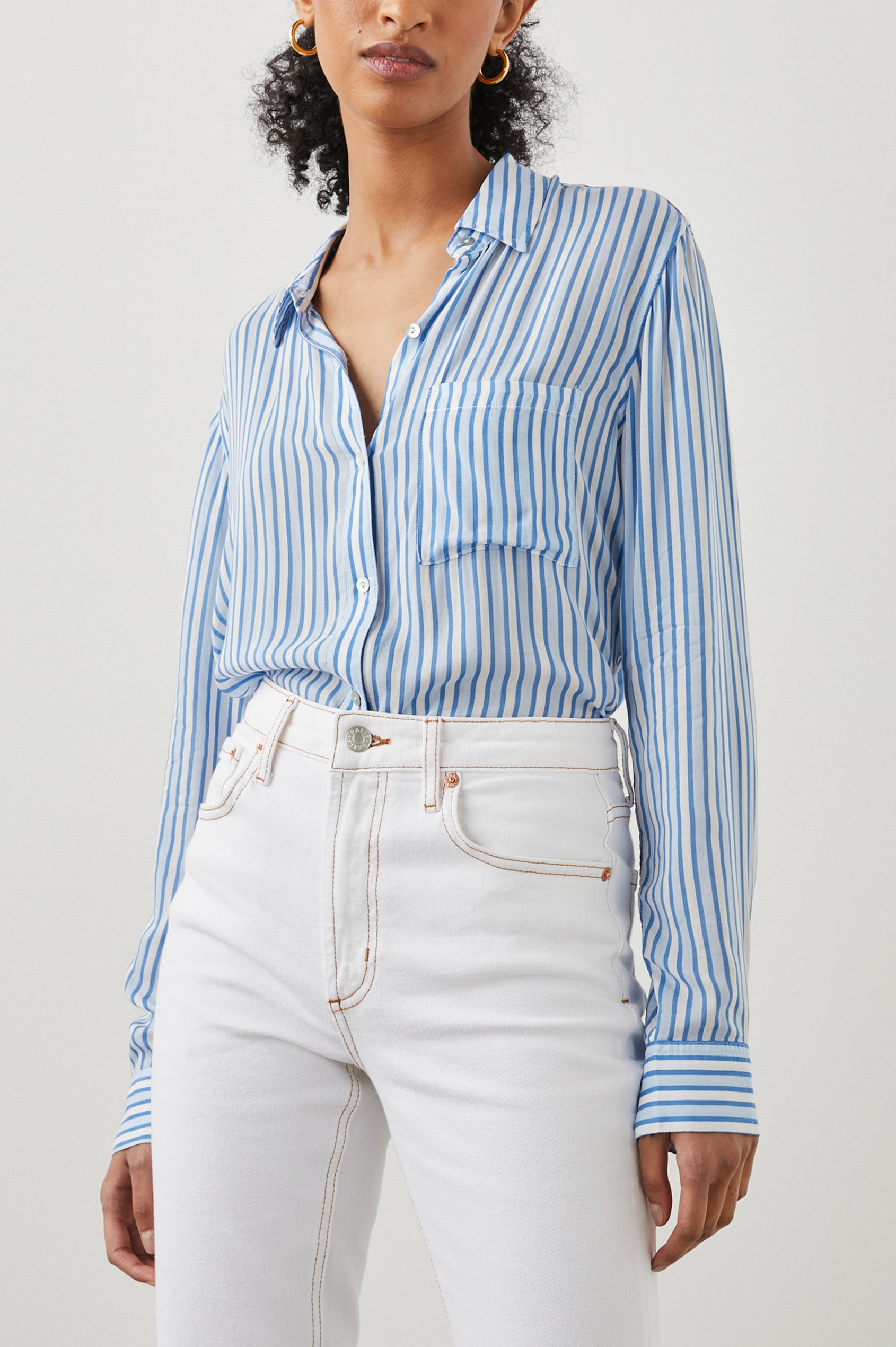 Josephine Long-Sleeve Button Down with a Chest Patch Pocket in Mar Stripe Colorway, vertical stripes in white and blues - Front Tucked View Featured on Model