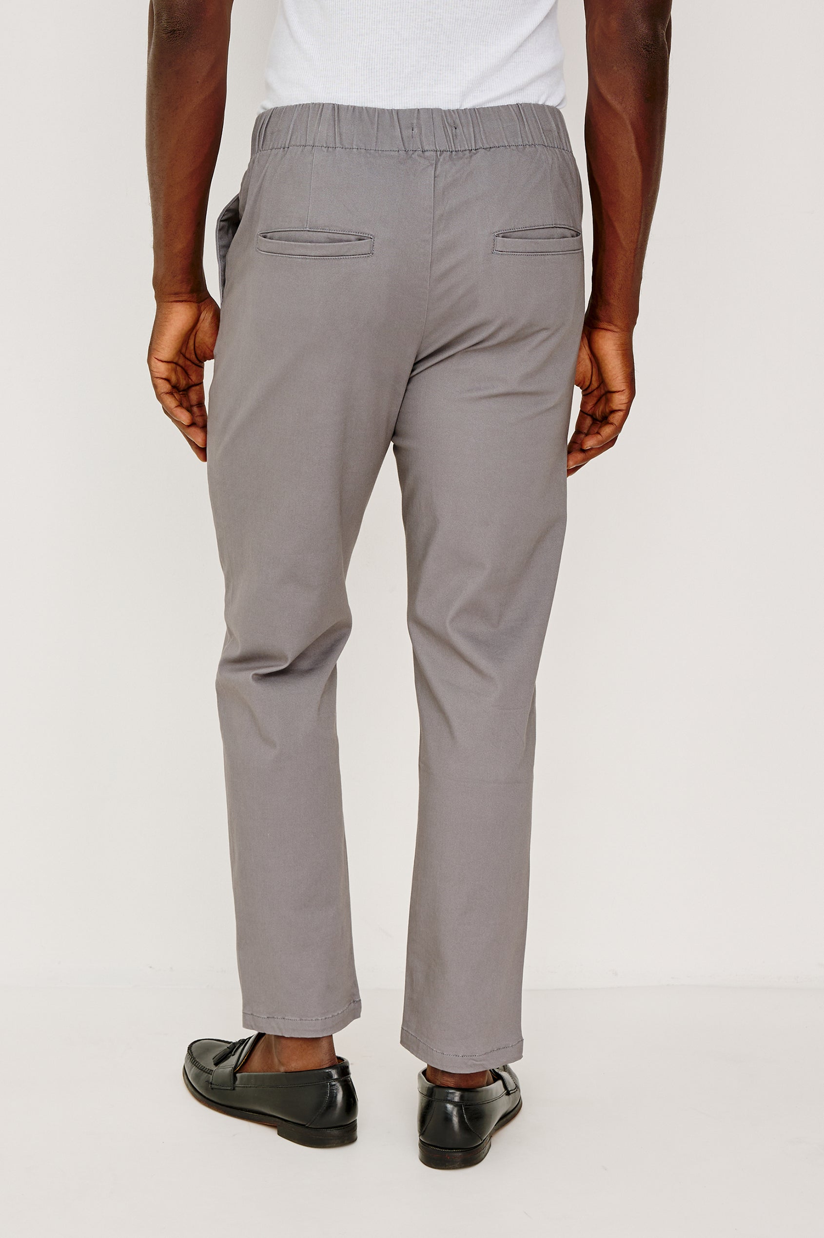 Julian Pants with an Elastic Waist, Two Front Pockets and Two Back Welt Pockets in Concrete Colorway - Back View Featured on Model