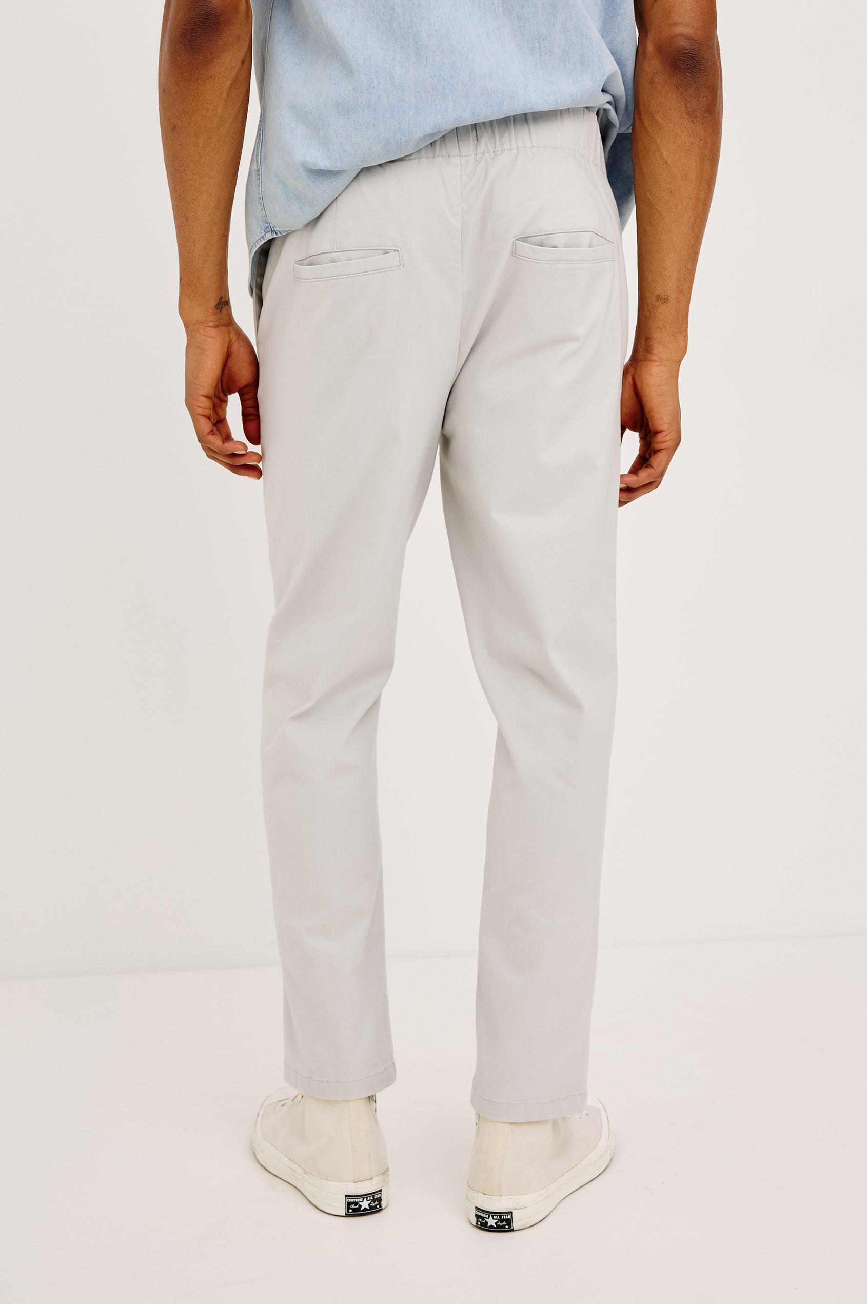 Julian Pants with an Elastic Waist, Two Front Pockets and Two Back Welt Pockets in Natural Colorway - Back View Featured on Model