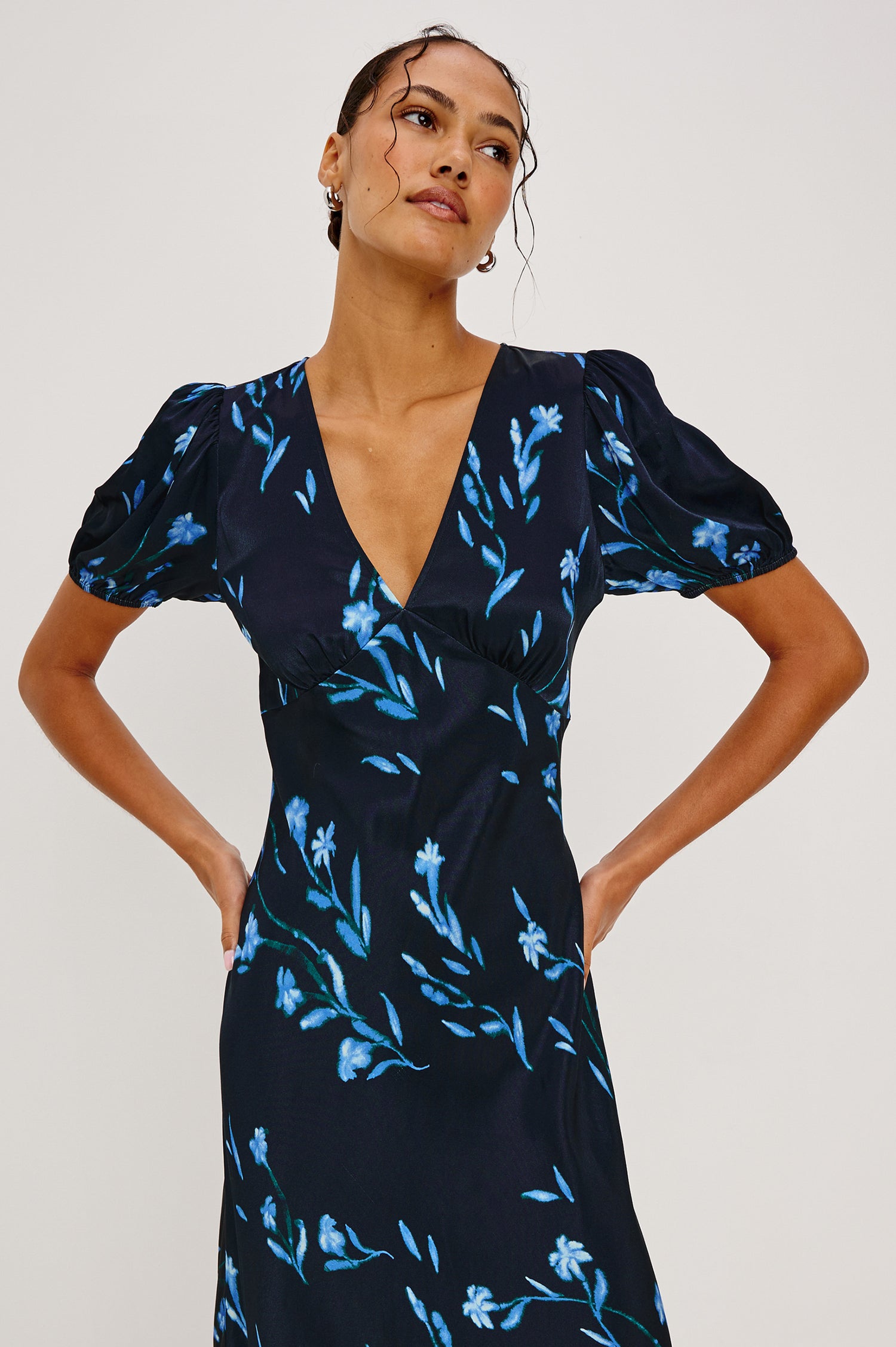 Junia Midi Dress in Satin Back Crepe With V-Neckline, Short Puff Sleeves, and Slip-on Design in Blue Carnation Colorway - Upper Body Front View Featured on Model