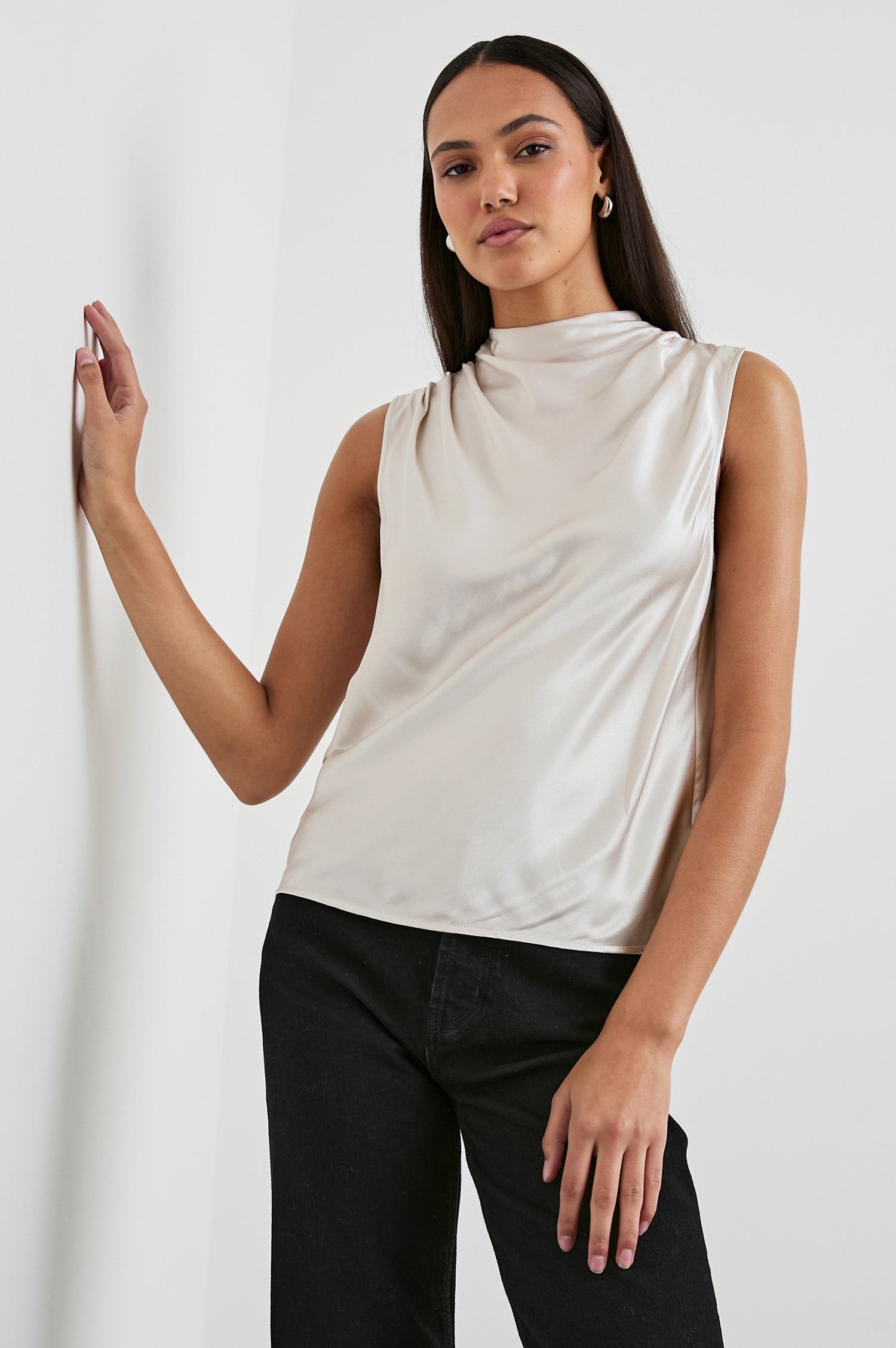 Kaleen Sleeveless Top with Mock Neck with Buttons and Keyhole on the Back and Draped Fabric on the Upper Chest in Ivory Colorway- Front View Featured on Model