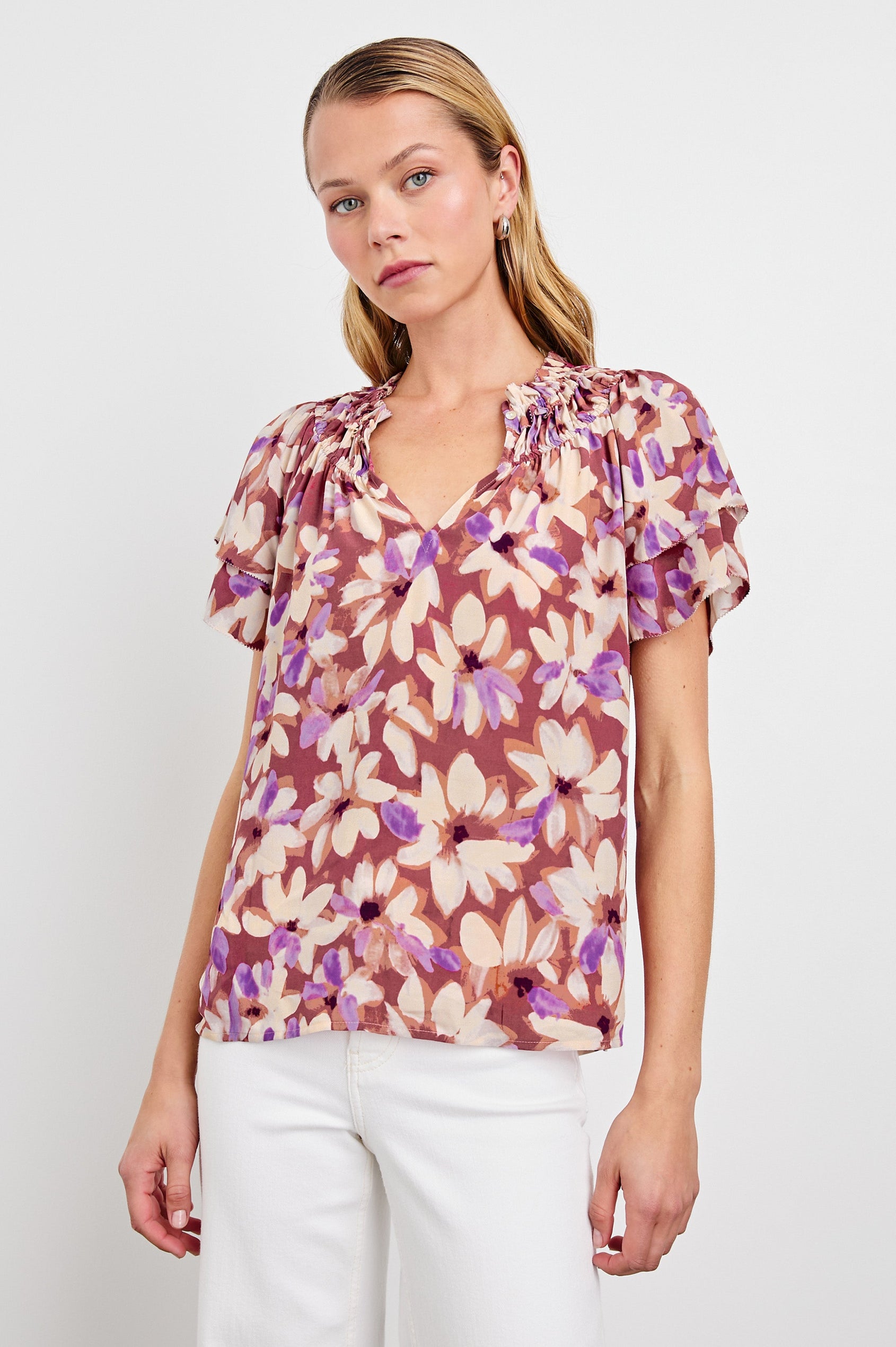 Kamila loose fit short sleeve shirt with a v neckline, ruffled collar, and flutter sleeves in Amaranth Colorway - front view on model, shirt untucked
