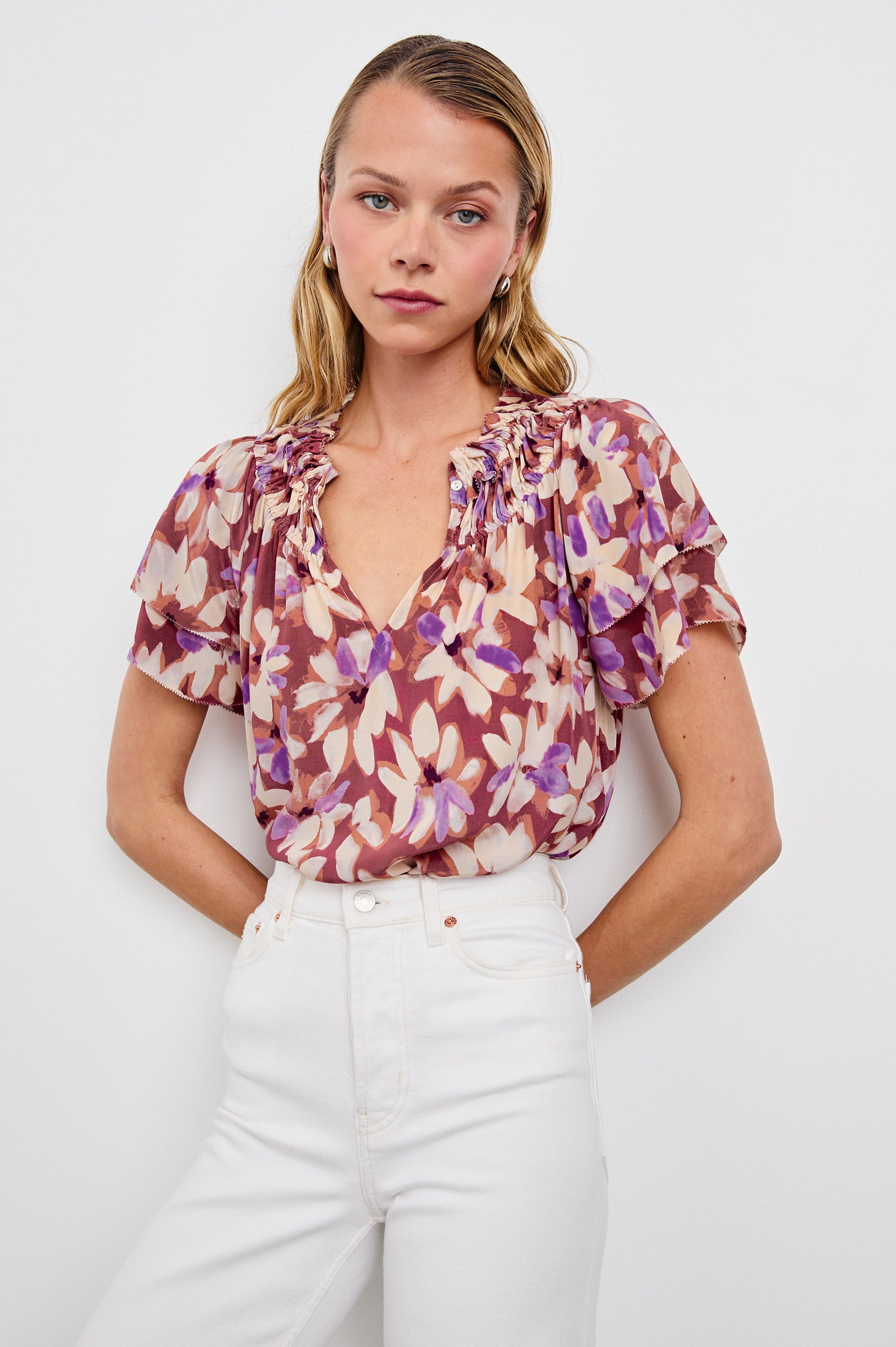 Kamila loose fit short sleeve shirt with a v neckline, ruffled collar, and flutter sleeves in Amaranth Colorway - front view on model