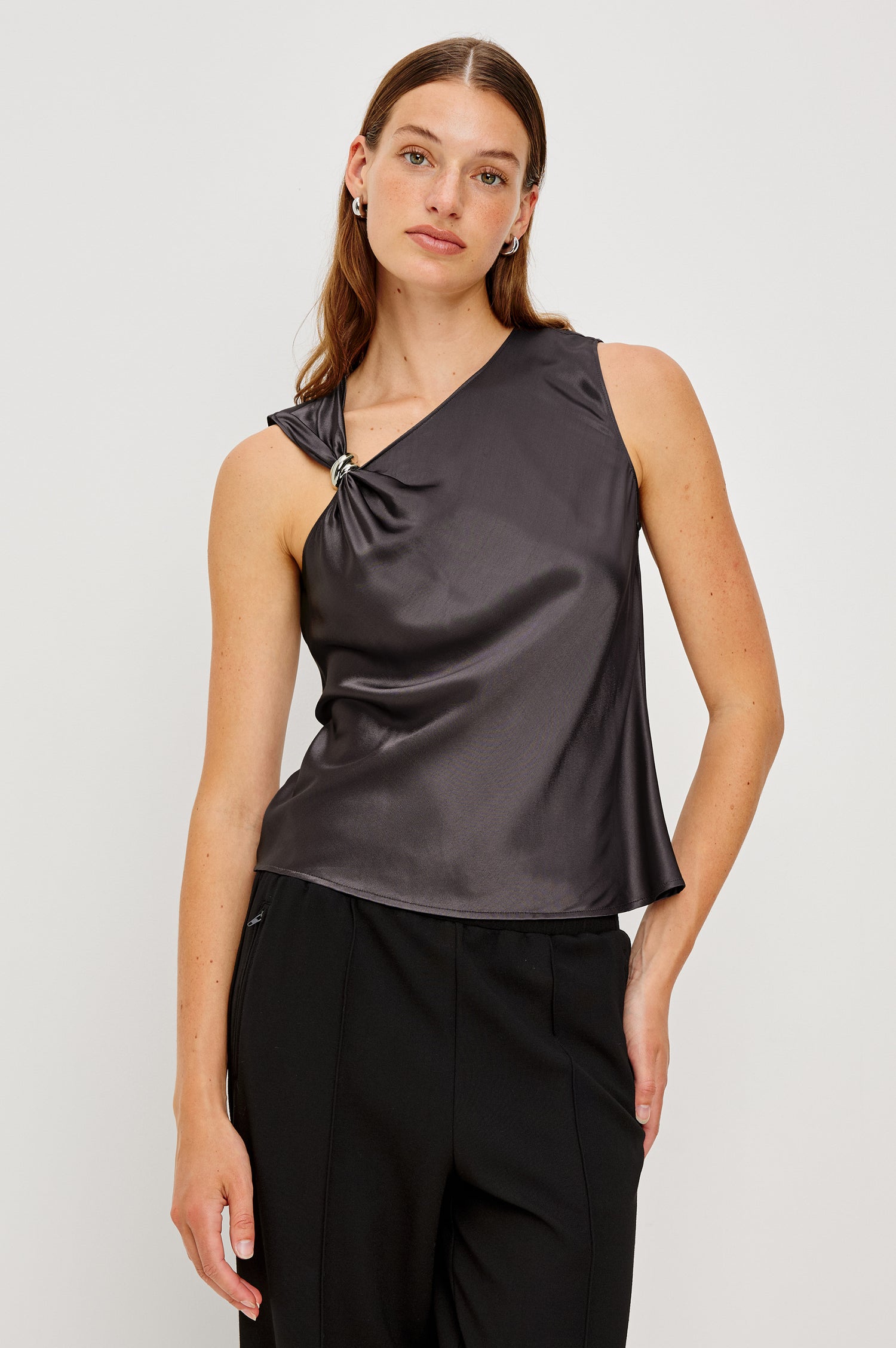 Karley Top features in luxe satin crepe. Details include metal hardware detailing and an asymmetrical shoulder strap. Front view featured on model.
