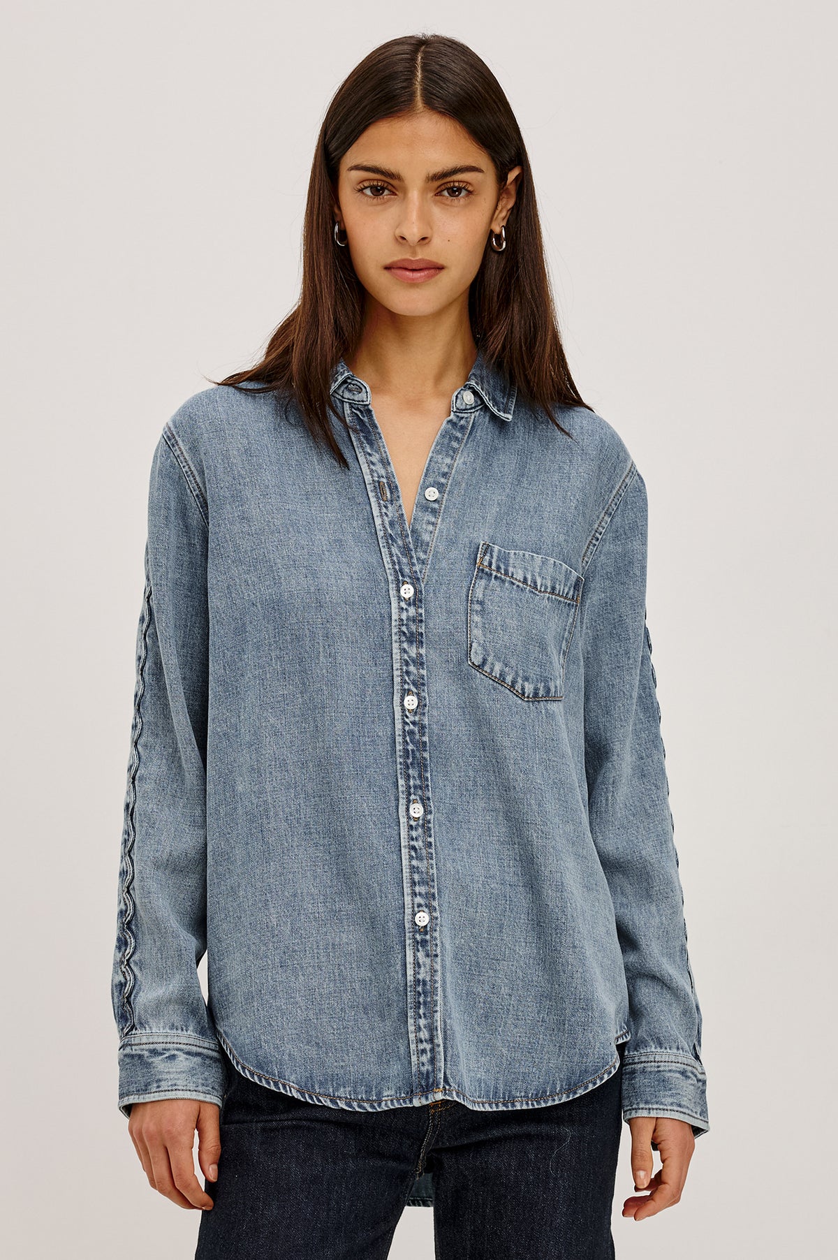 Kellan Shirt in TENCEL™ Denim With Relaxed Fit, Chest Patch Pocket, Zig-Zag Trim at Long Sleeves, Front Buttons, and Shirttail Hem in Mid Blue Colorway - Upper Body Front View Featured on Model.
