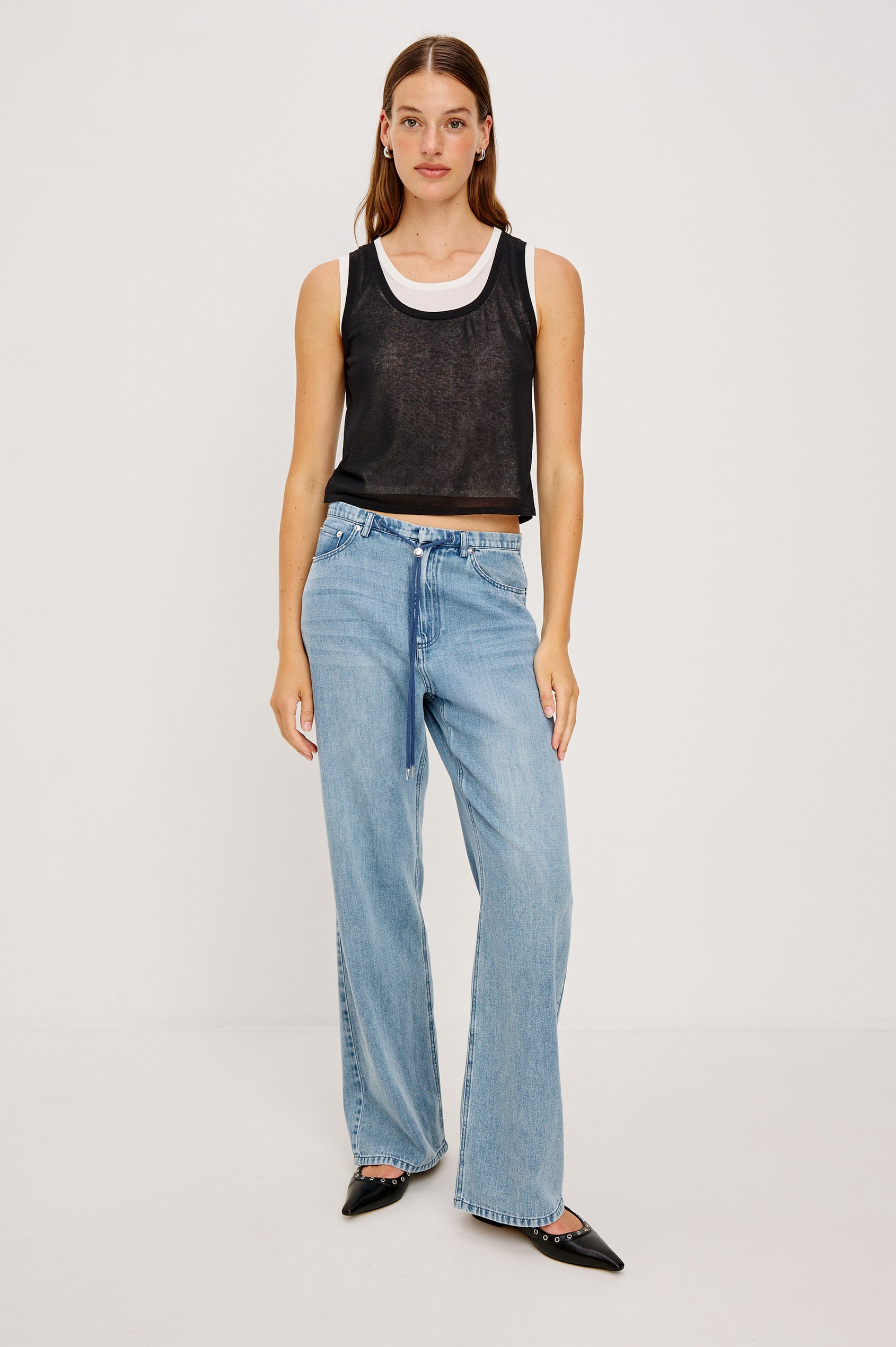 The Kelly is a semi sheer double layered scoop neck tank top, black on top and ivory as under layer. Front full body view featured on model.