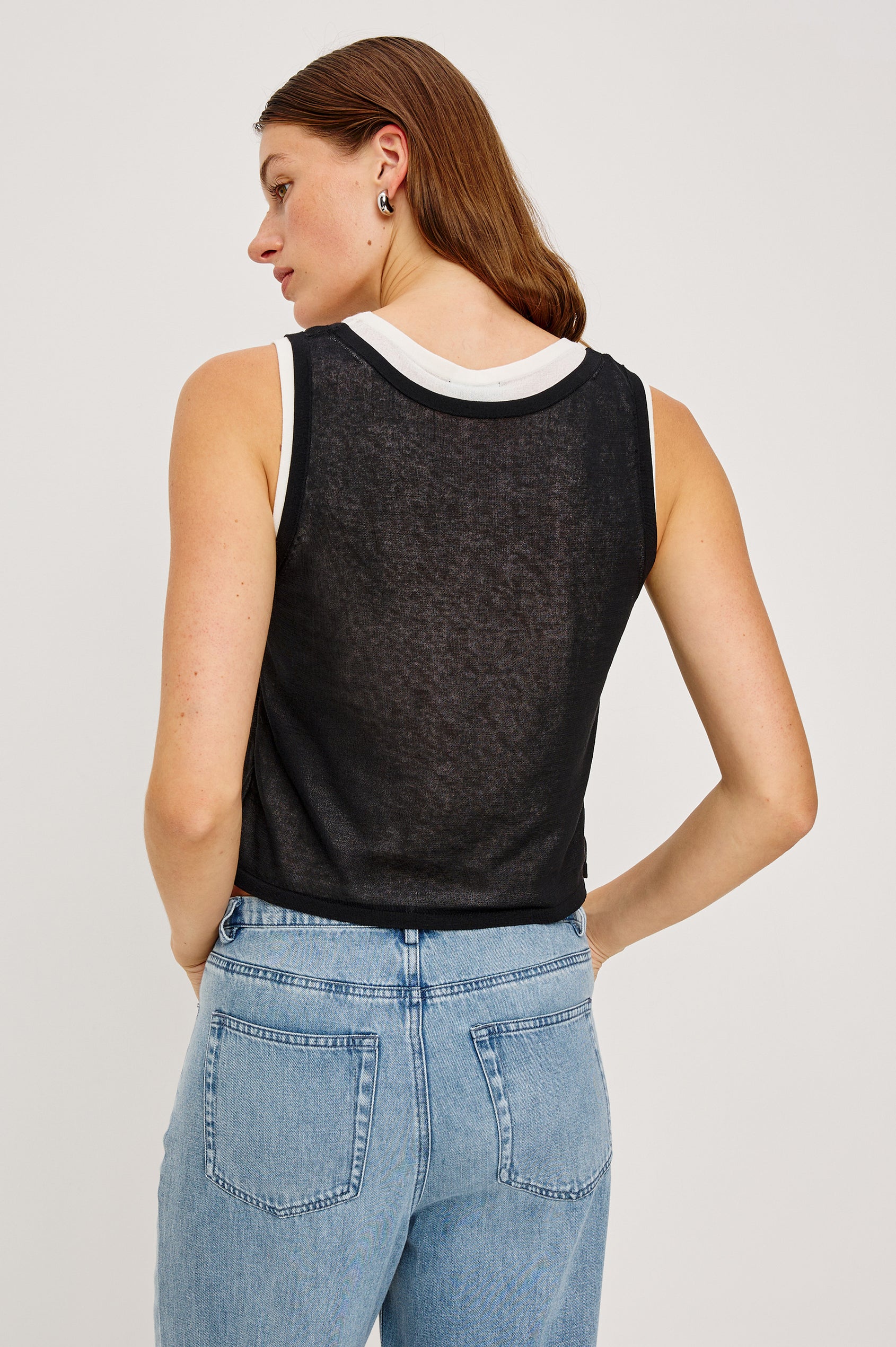 The Kelly is a semi sheer double layered scoop neck tank top, black on top and ivory as under layer. Back view featured on model.