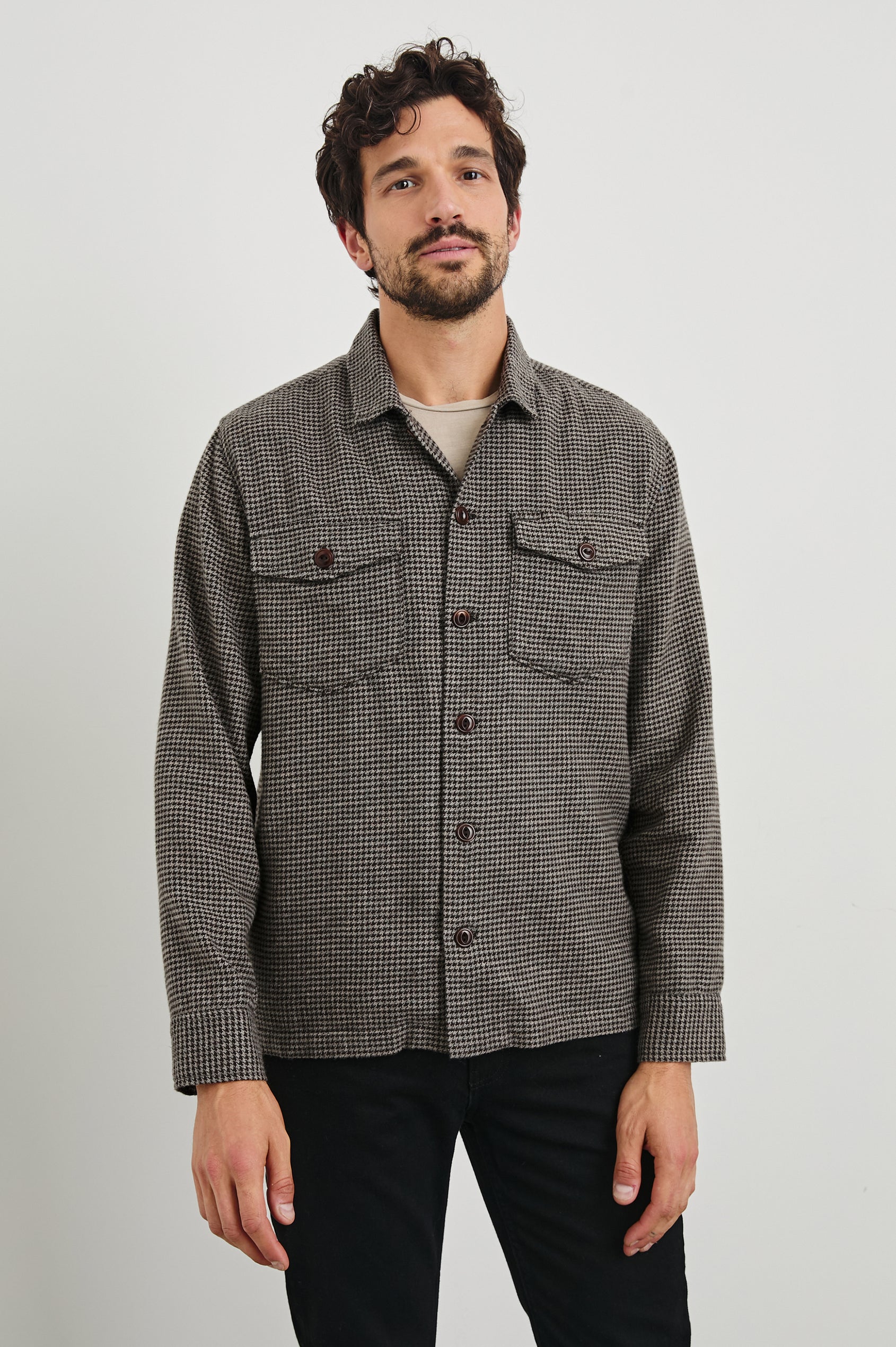 Kerouac Long-Sleeve Shirt Jacket with Button Closure and Two Button Chest Flap Pockets in Mire Colorway, a Tan and Black Houndstooth - Front View Featured on Model