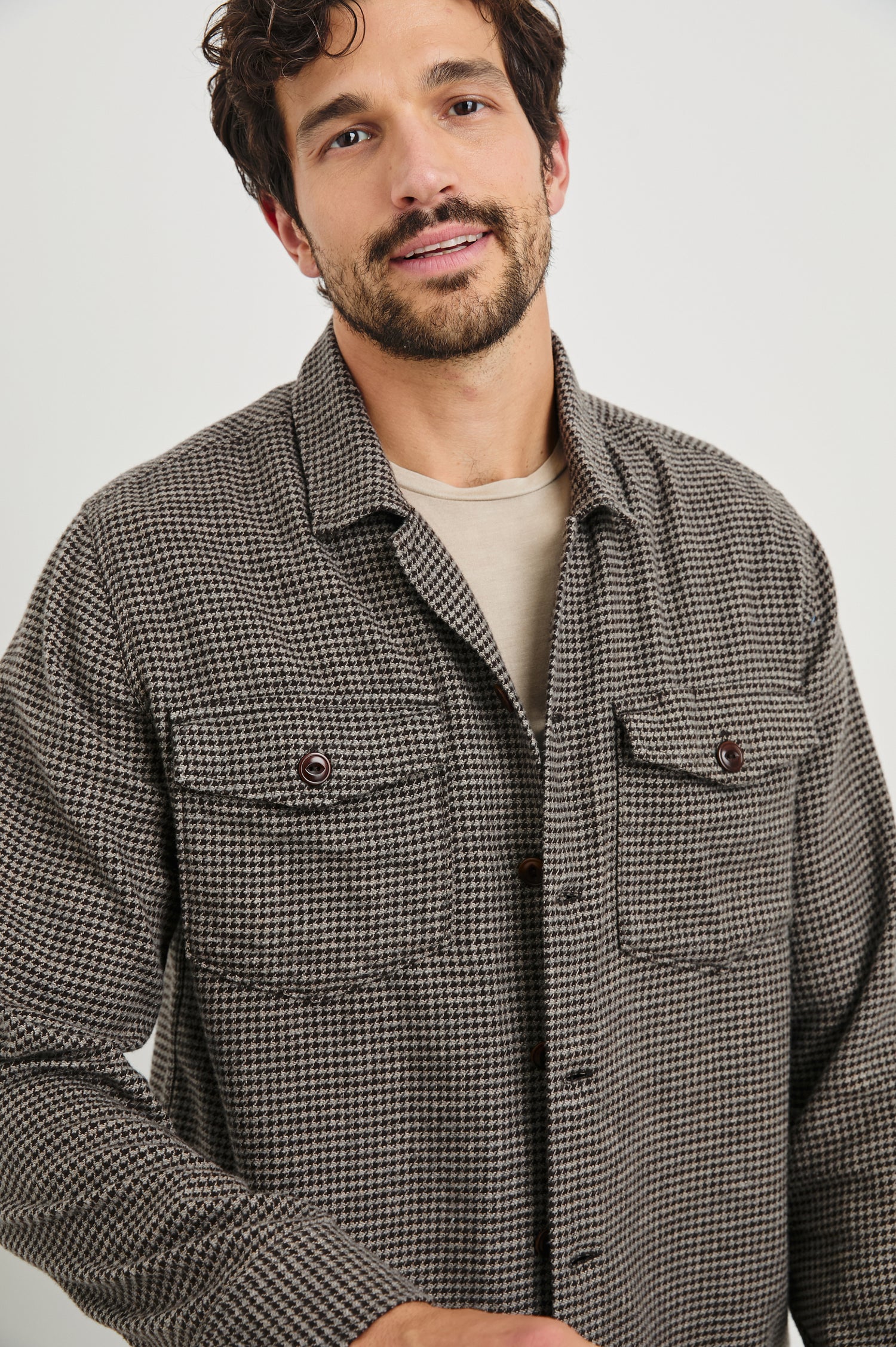 Kerouac Long-Sleeve Shirt Jacket with Button Closure and Two Button Chest Flap Pockets in Mire Colorway, a Tan and Black Houndstooth - Front View Featured on Model