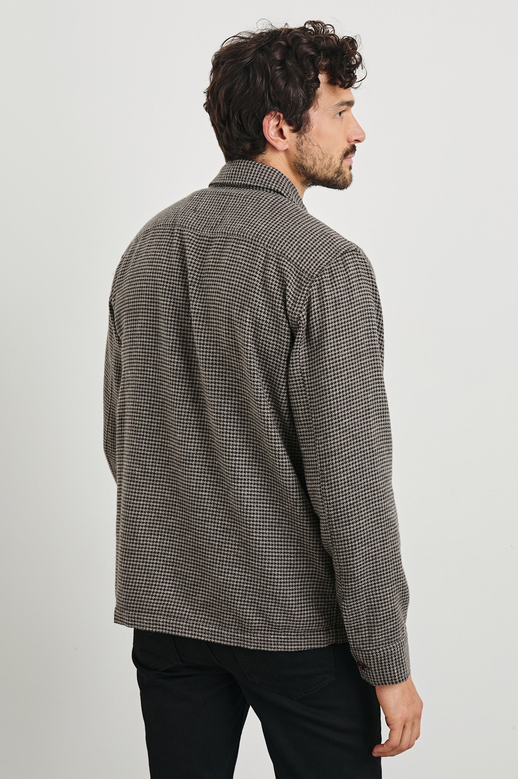 Kerouac Long-Sleeve Shirt Jacket with Button Closure and Two Button Chest Flap Pockets in Mire Colorway, a Tan and Black Houndstooth - Back View Featured on Model
