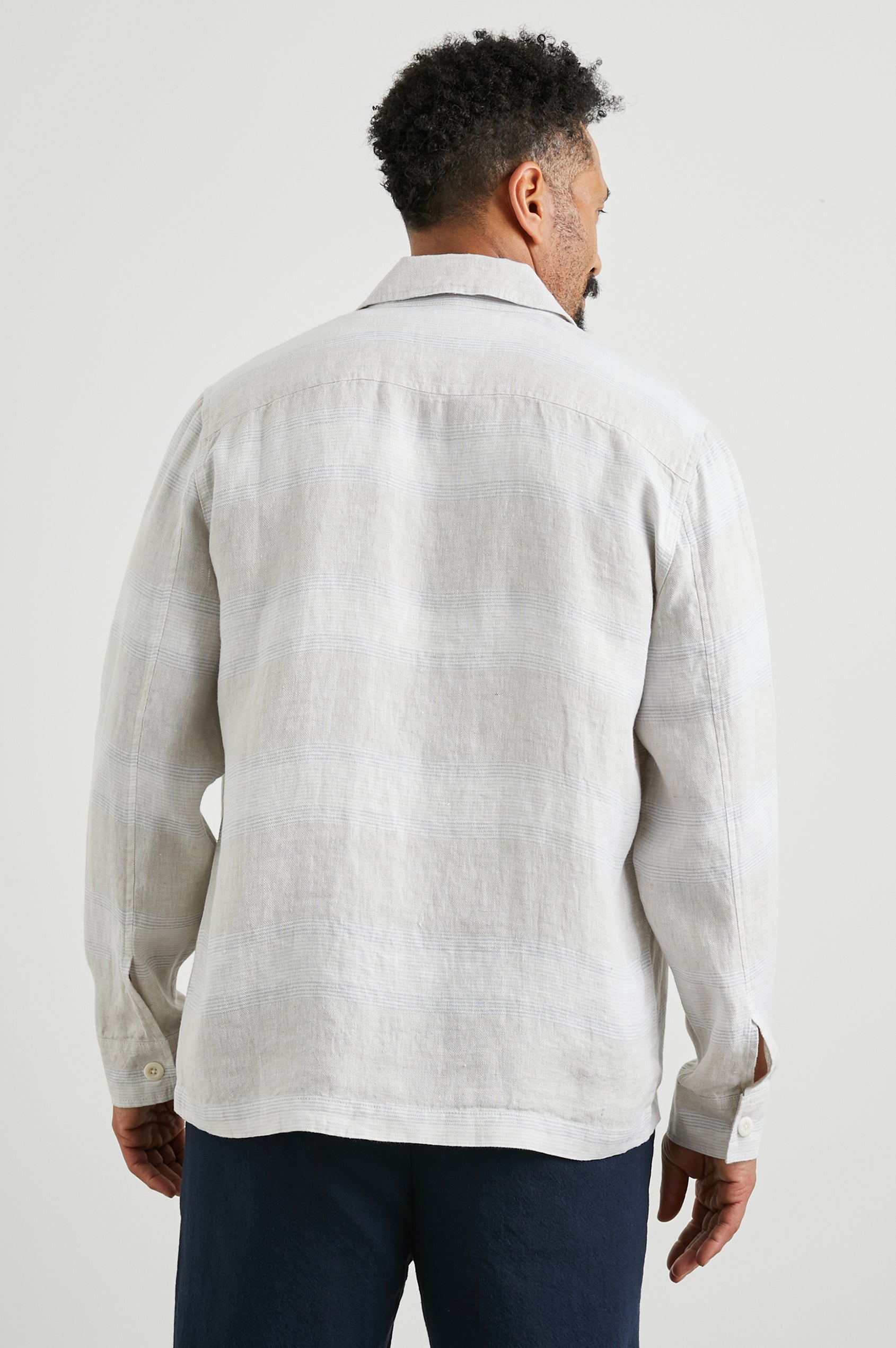 Kerouac Long-Sleeve Shirt Jacket with Button Closure and Two Button Chest Flap Pockets in Wicker Graphite Stripe Colorway, Grey and White Horizontal Stripes on Wicker  - Back Unbuttoned View Featured on Model