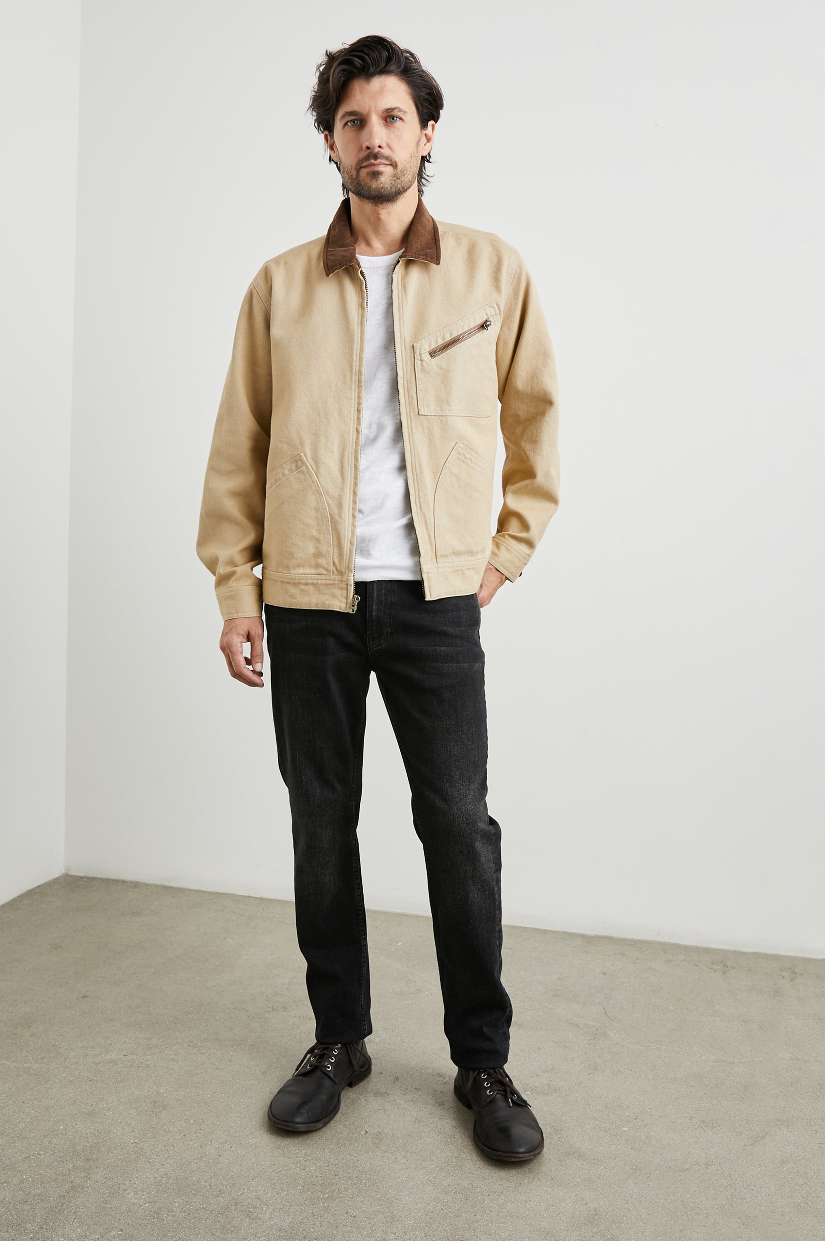 Ketter Zip Up Jacket with Two Curved Front Patch Pockets, a Diagonally Zippered Chest Patch Pocket and Adjustable Button Straps on the Hem in Duck Colorway, a Tan with a Darker Brown Collar - Front Full Body View Featured on Model