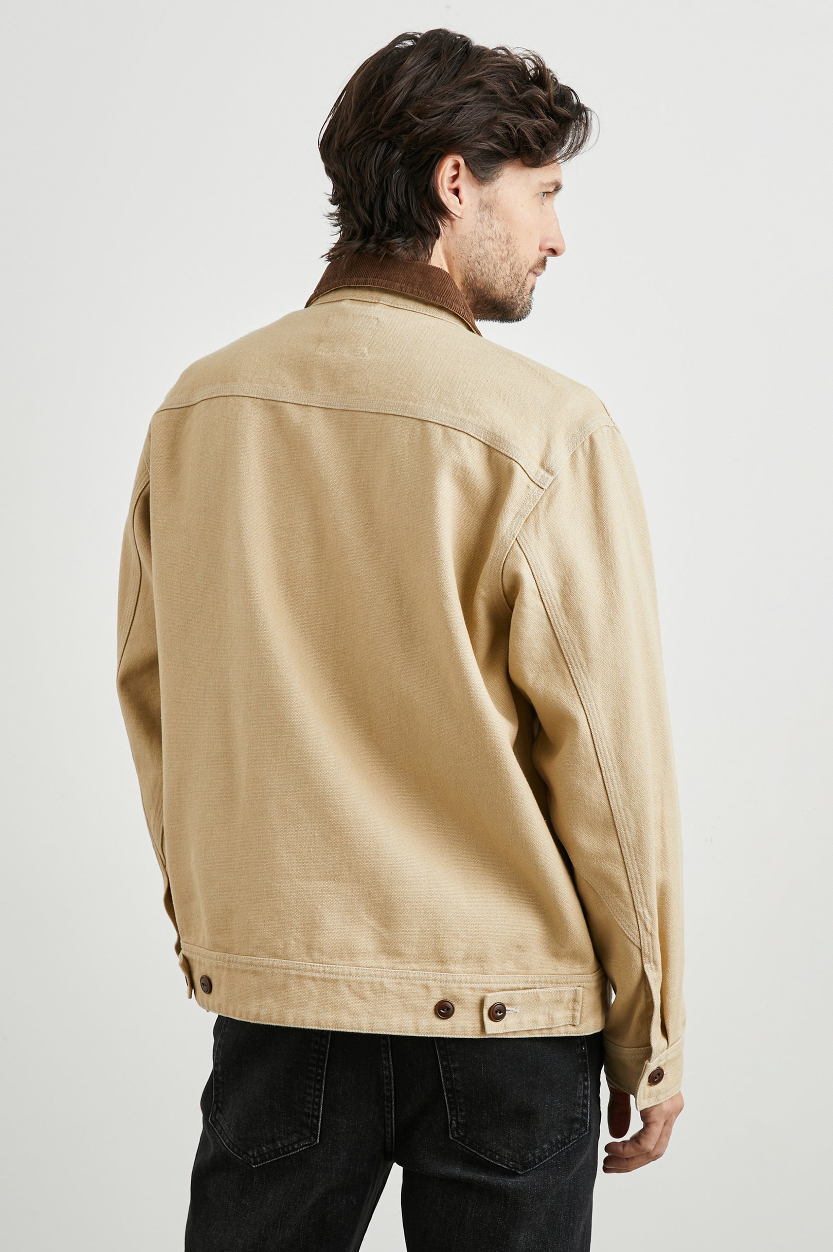 Ketter Zip Up Jacket with Two Curved Front Patch Pockets, a Diagonally Zippered Chest Patch Pocket and Adjustable Button Straps on the Hem in Duck Colorway, a Tan with a Darker Brown Collar - Back View Featured on Model