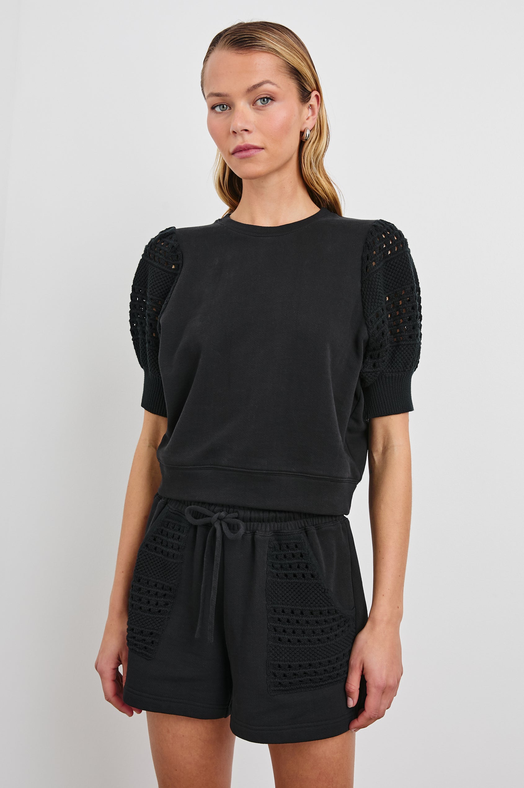 Kimberly Sweatshirt with Elbow-Length, Crochet and Knit Sleeves, Ribbed Cuffs, and Crew Neckline in Black Colorway - Front View Featured on Model