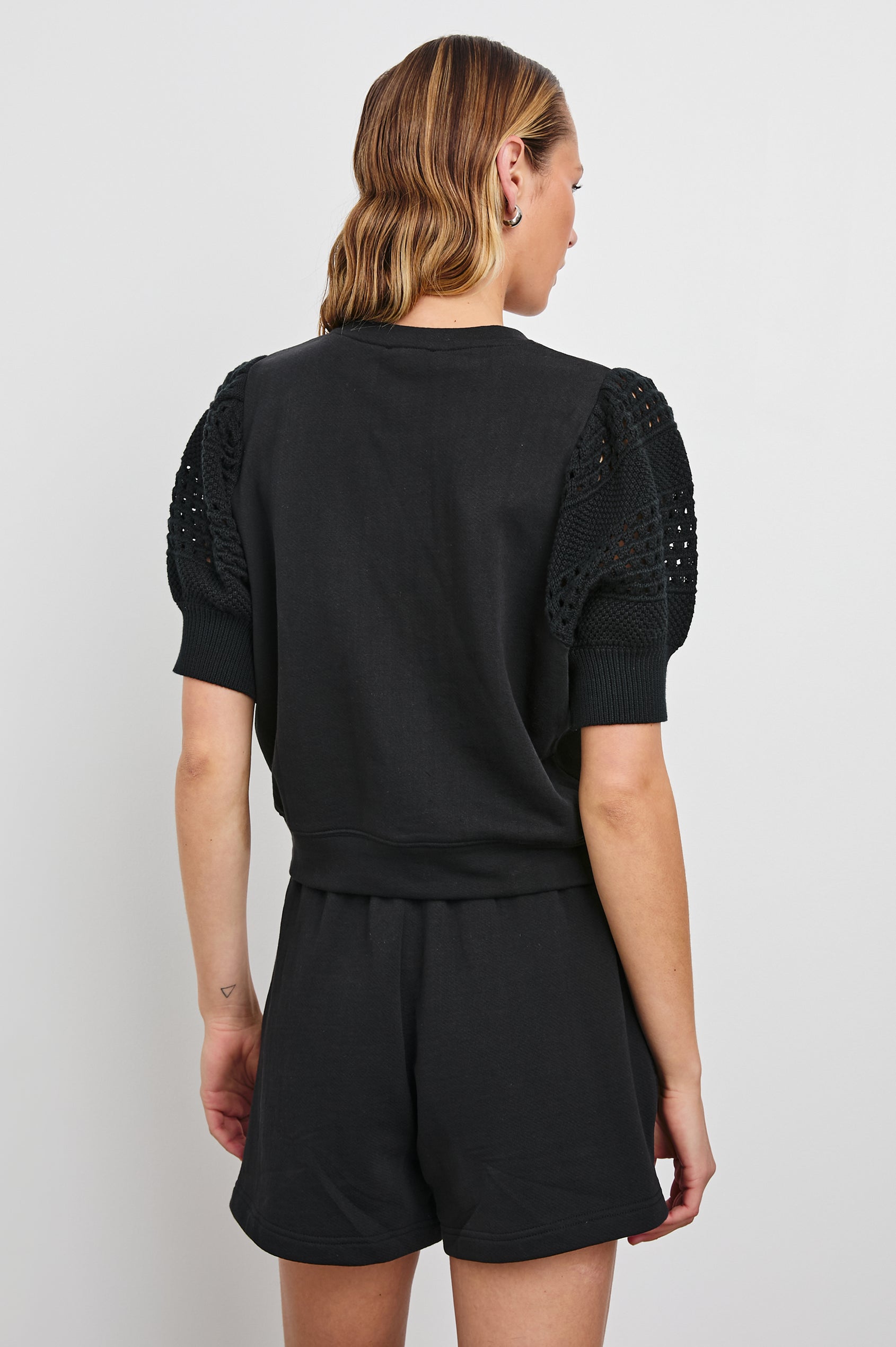 Kimberly Sweatshirt with Elbow-Length, Crochet and Knit Sleeves, Ribbed Cuffs, and Crew Neckline in Black Colorway - Back View Featured on Model