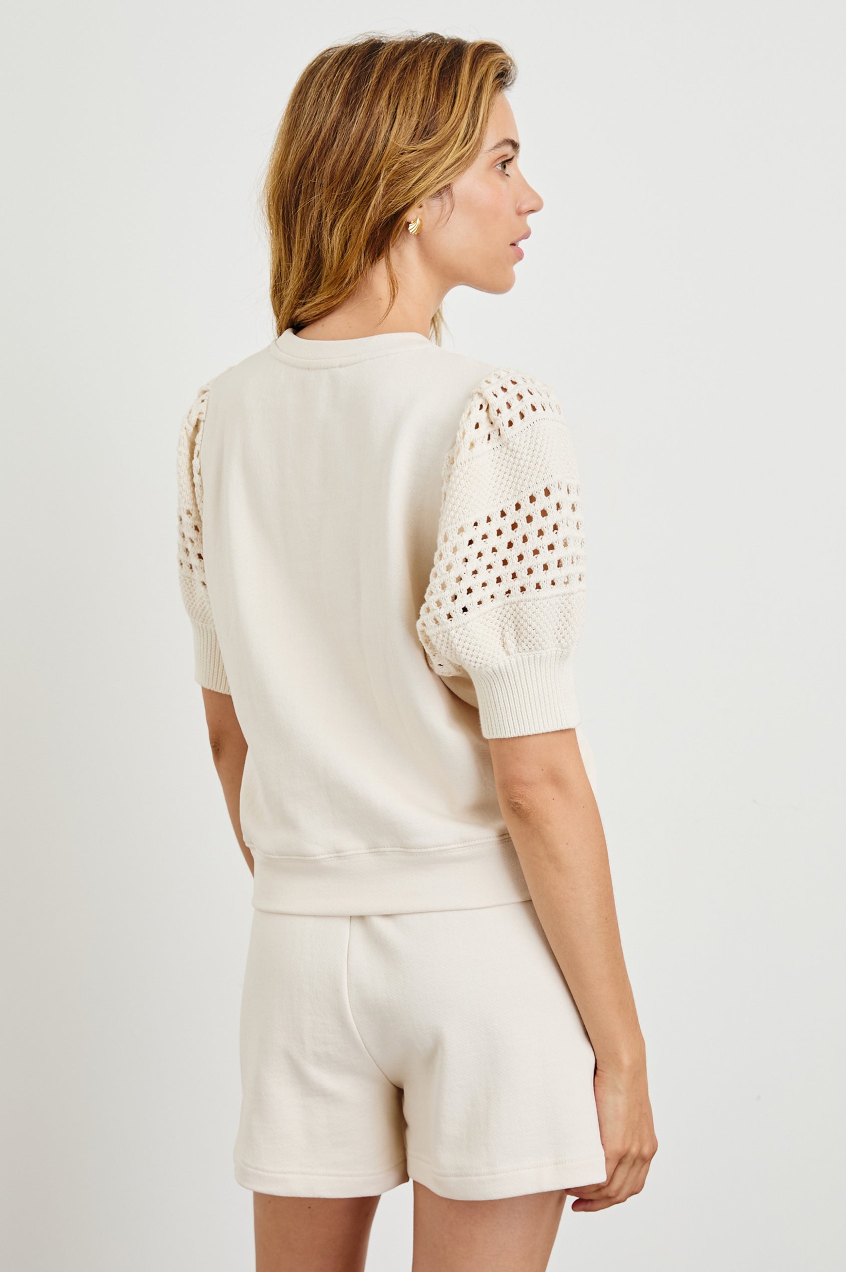 Kimberly Sweatshirt with Elbow-Length Sleeves, Ribbed Cuffs, Crew Neckline, and Crochet and Knit Sleeves in Oat Colorway - Back View Featured on Model