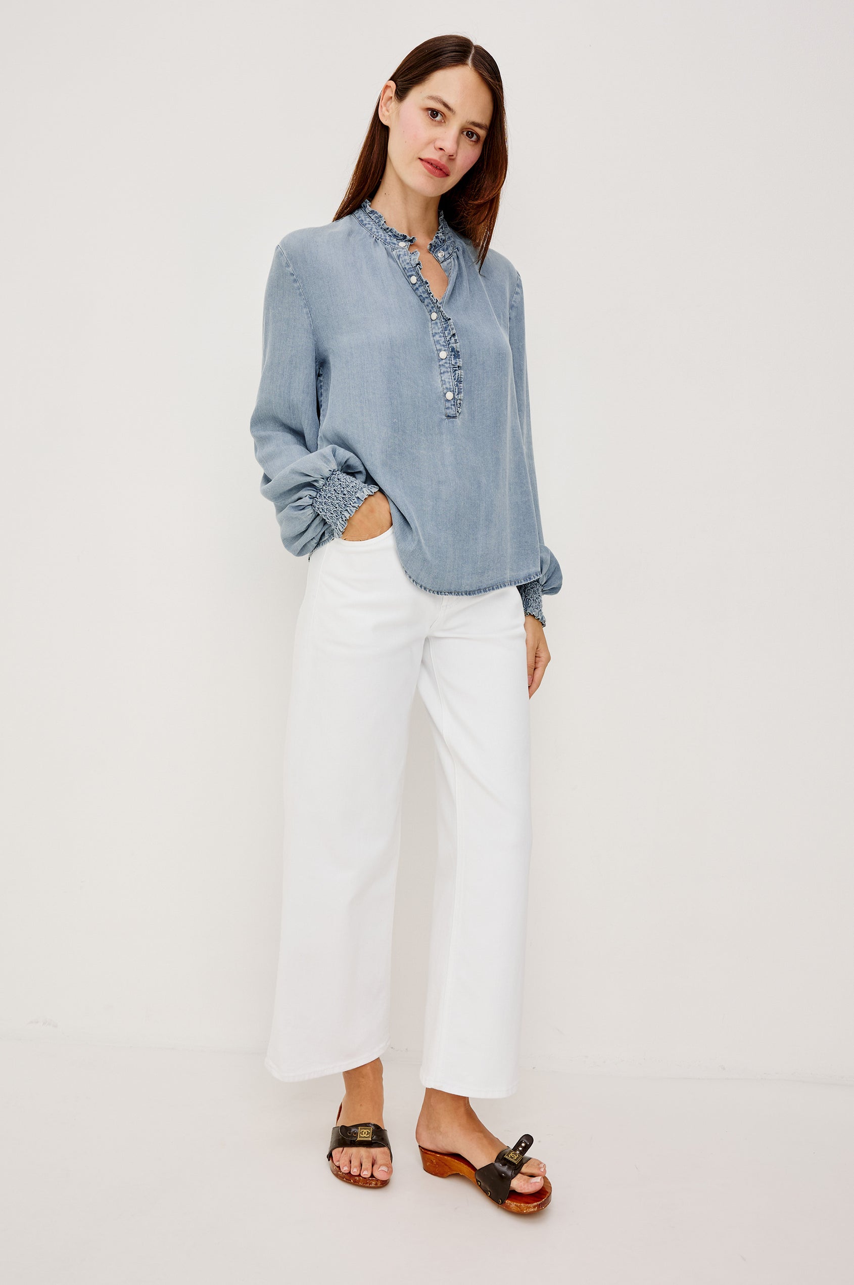 Kimmy TENCELâ„¢ Denim Top With Band Collar Half-Button Placket Long Gathered Sleeves With Smocked Cuffs and Loose Relaxed Fit in Washed Blue Colorway - Full Body Front View Featured on Model