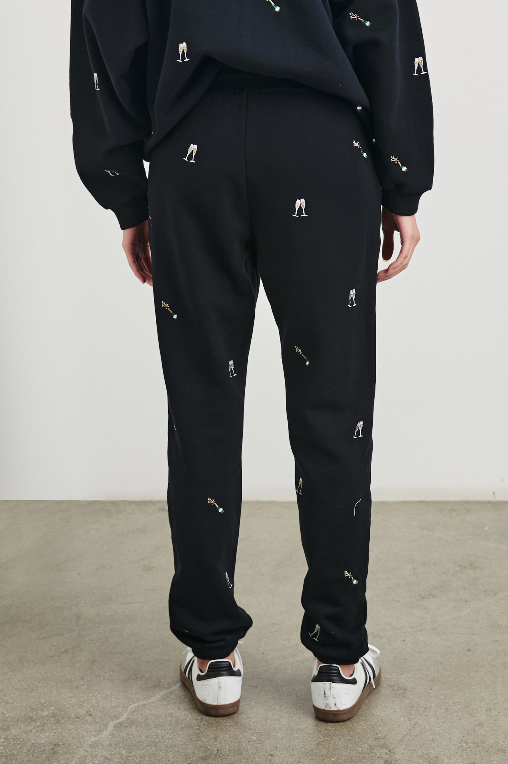 Kingston Pants with Elastic Cuffs and Waist with Drawcord in Black Champagne Embroidery Colorway, Champagne Glasses on Black - Back View Featured on Model