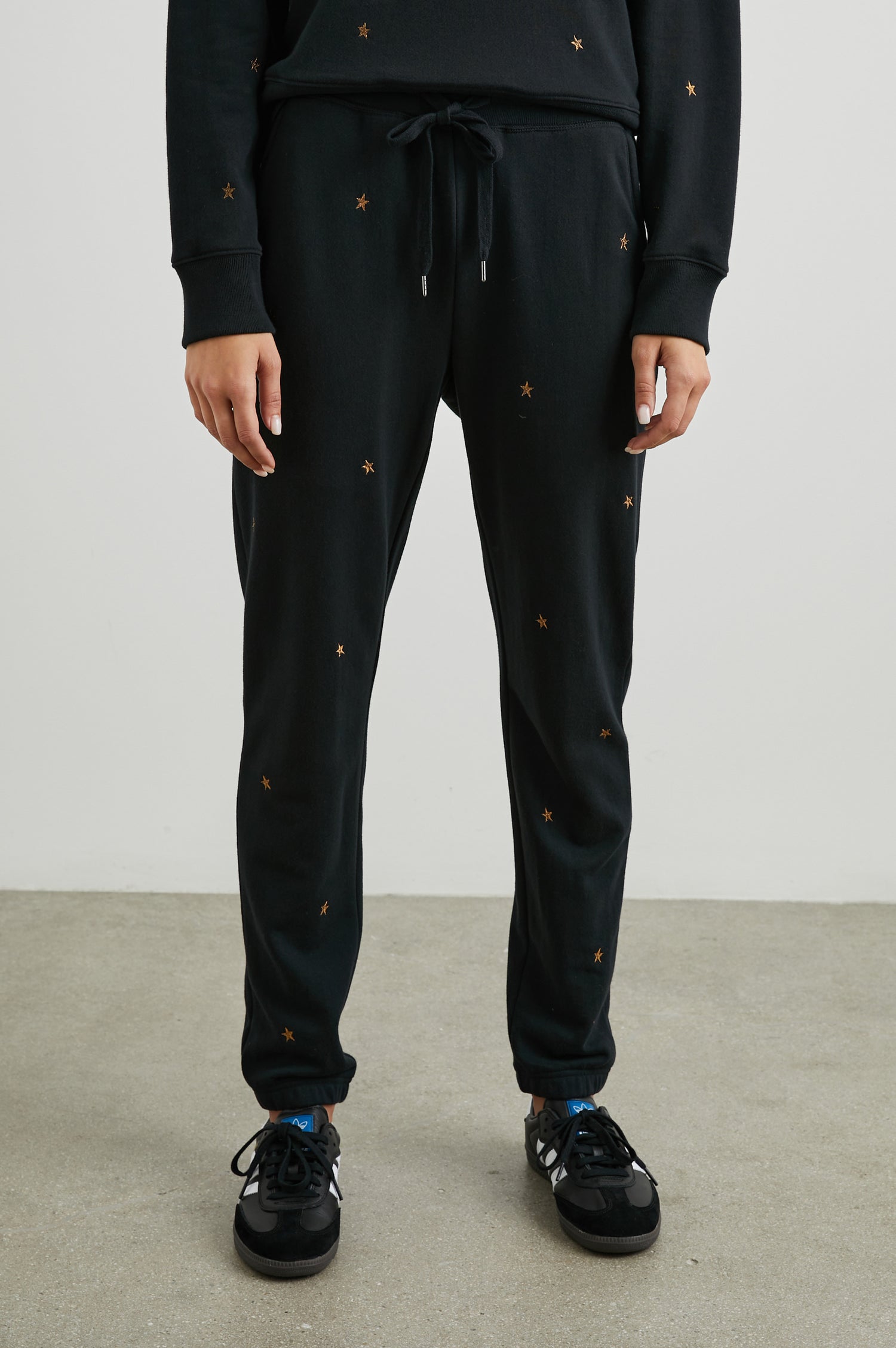 Kingston Sweatpants with Elastic Cuffs and Waist with Drawcord in Bronze Star Embroidery Colorway, Bronze Stars on Black - Front View Featured on Model