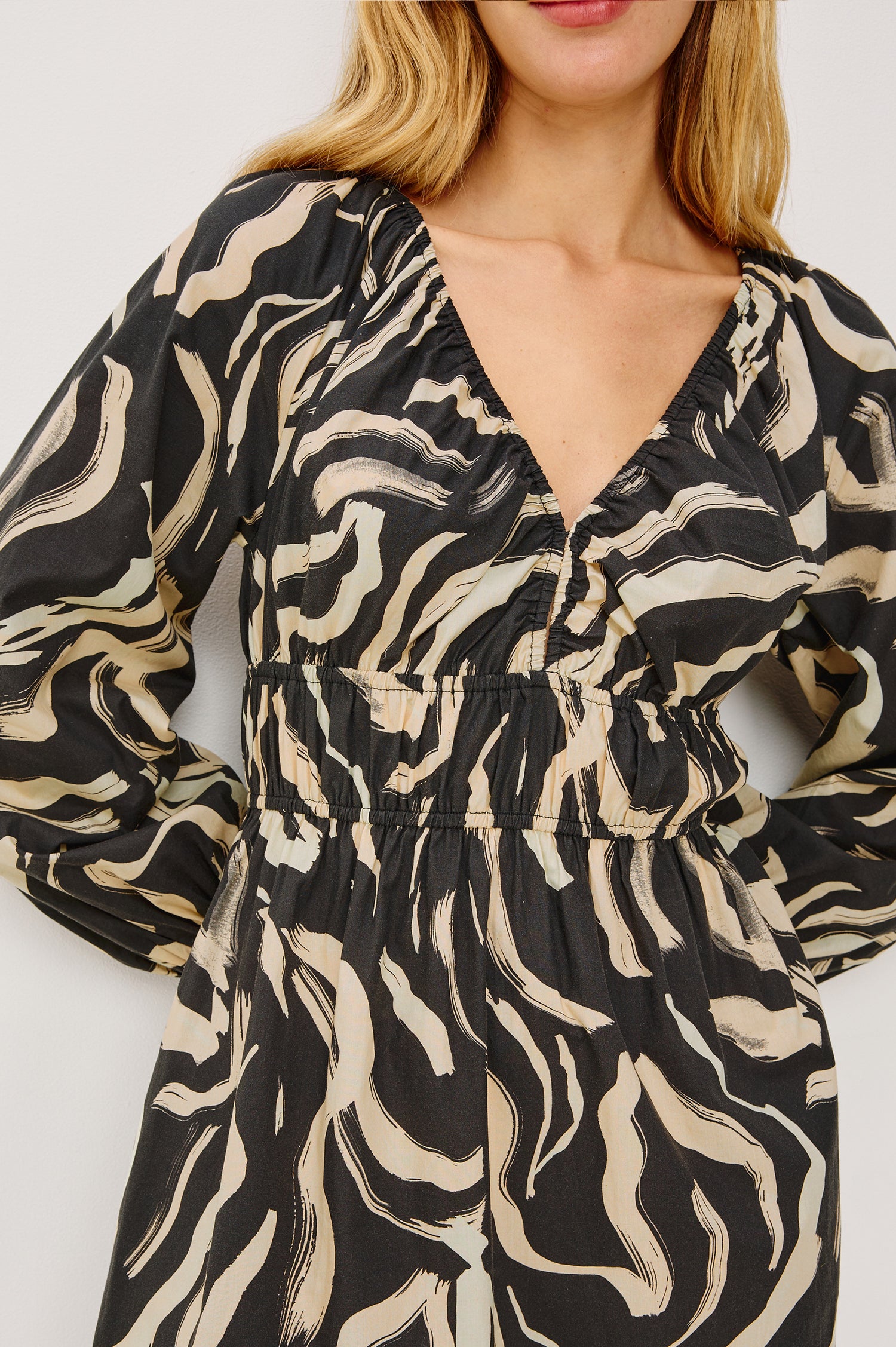 Krina Mini Dress in Cotton Poplin With Deep V-Neckline, Center Front Ties, Long Billowing Sleeves, and Tiered Hem in Caicos Colorway - Upper Body Front Close Up View Featured on Model