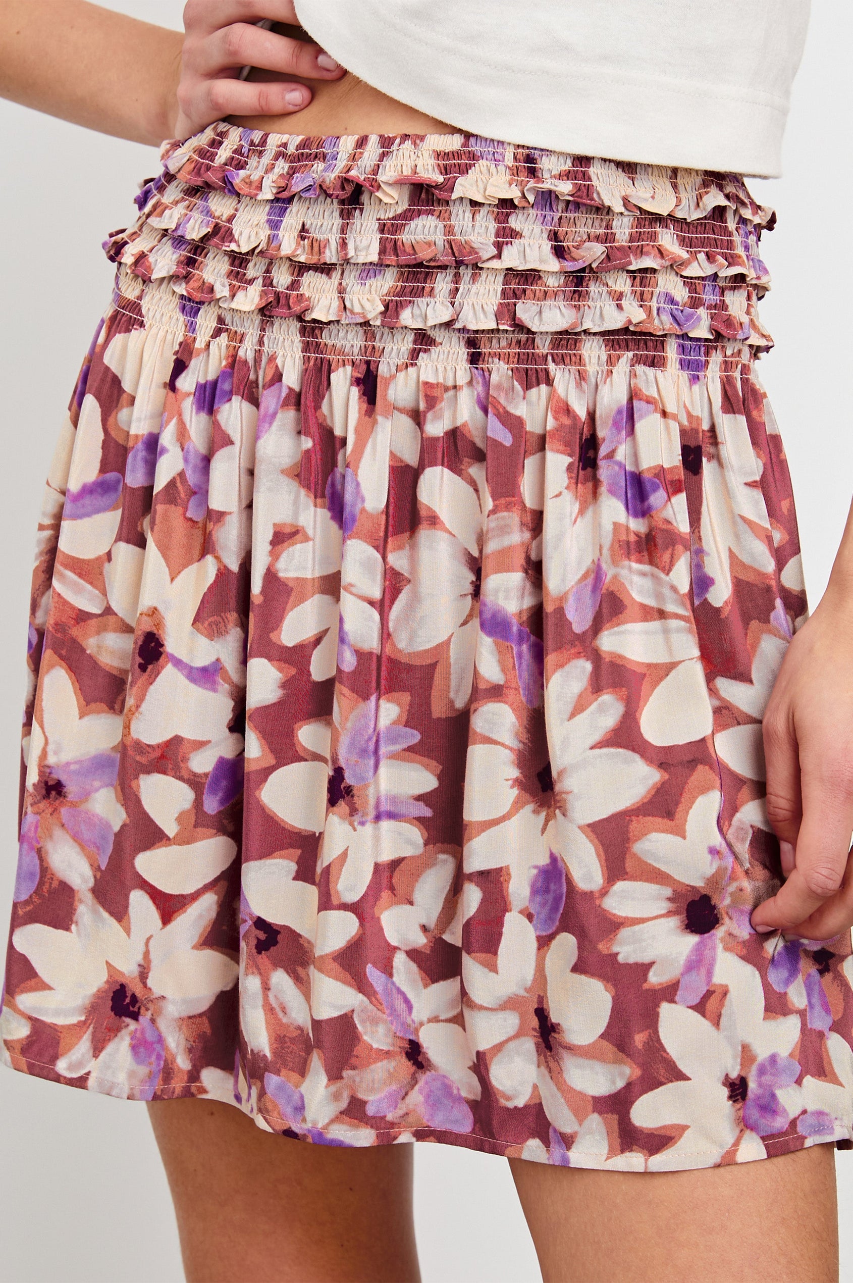 Kumi high waisted mini skirt with ruffled waist band in Amaranth Colorway - close up of details on model