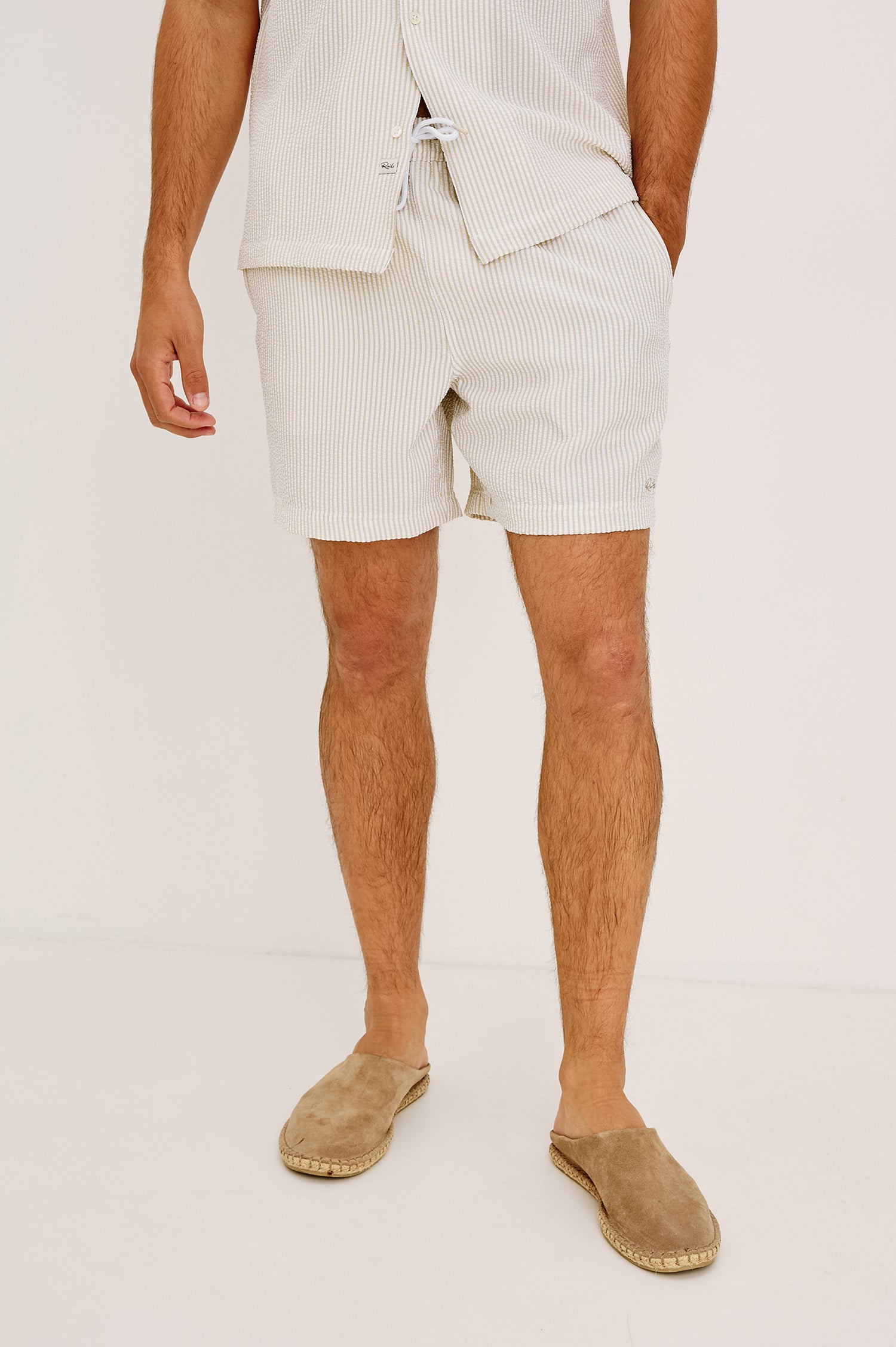 La Brea Mid-Length Swim Shorts With Adjustable Waist Drawstring Ties and Side Pockets in Khaki White Seersucker Colorway - Lower Body Front View Featured on Model