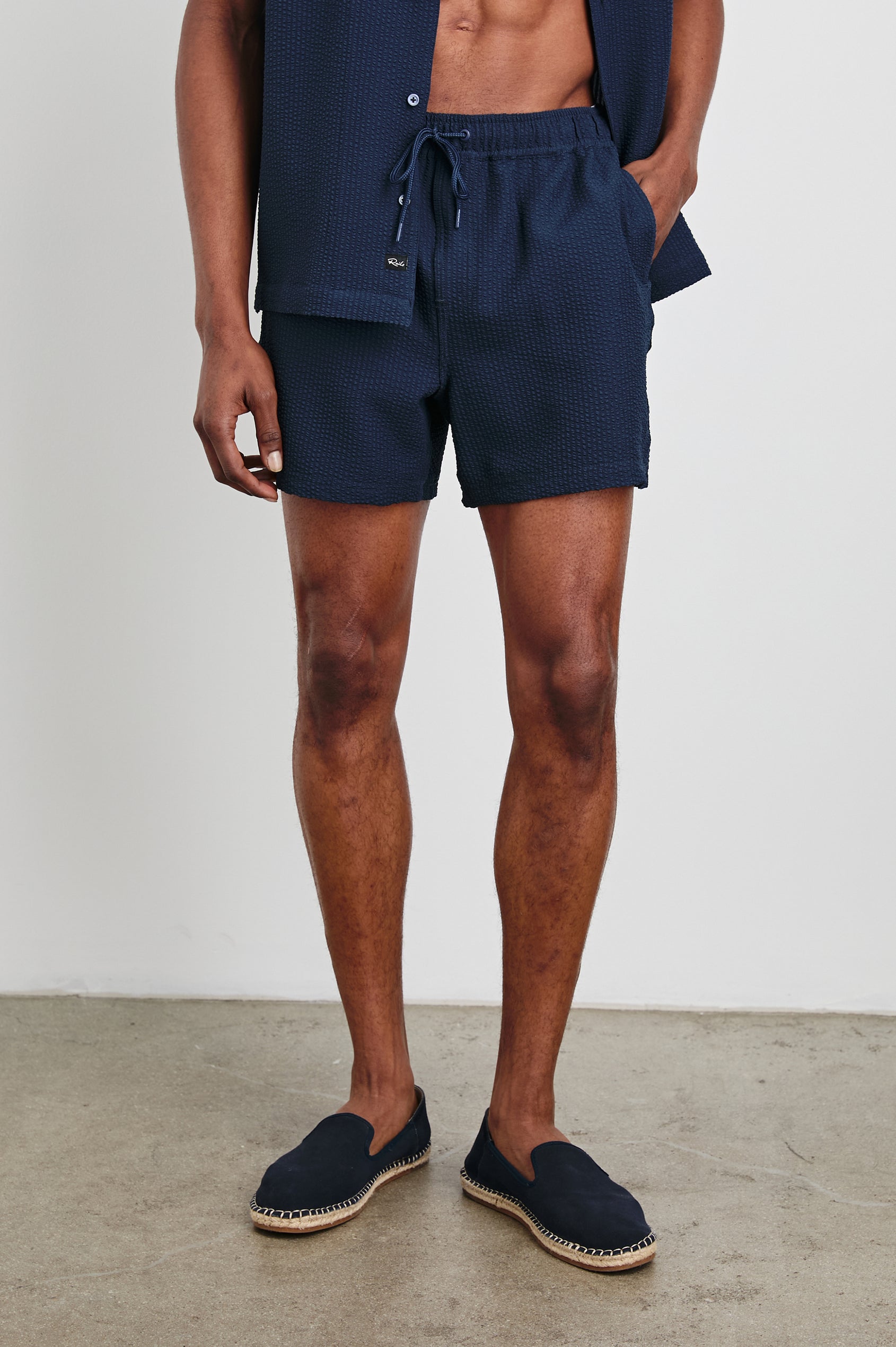 La Brea textured mid-length swim short with adjustable waist drawstring in Navy Seersucker - front view on model