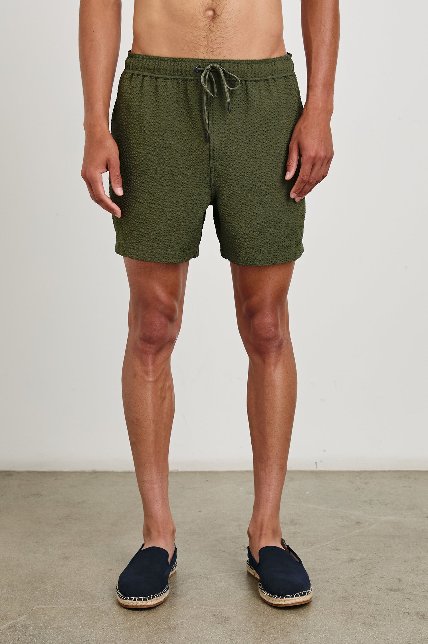 La Brea textured mid-length swim short with adjustable waist drawstring in Olive Seersucker - front view on model