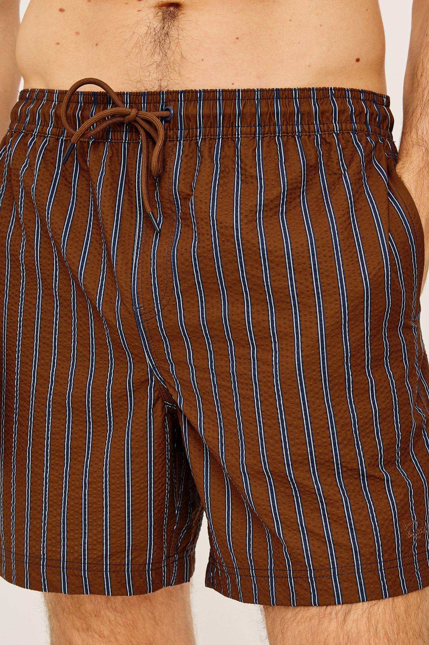 La Brea Mid-Length Swim Shorts With Adjustable Waist Drawstring Ties and Side Pockets in Rust Navy Stripe Colorway - Lower Body Front View Featured on Model