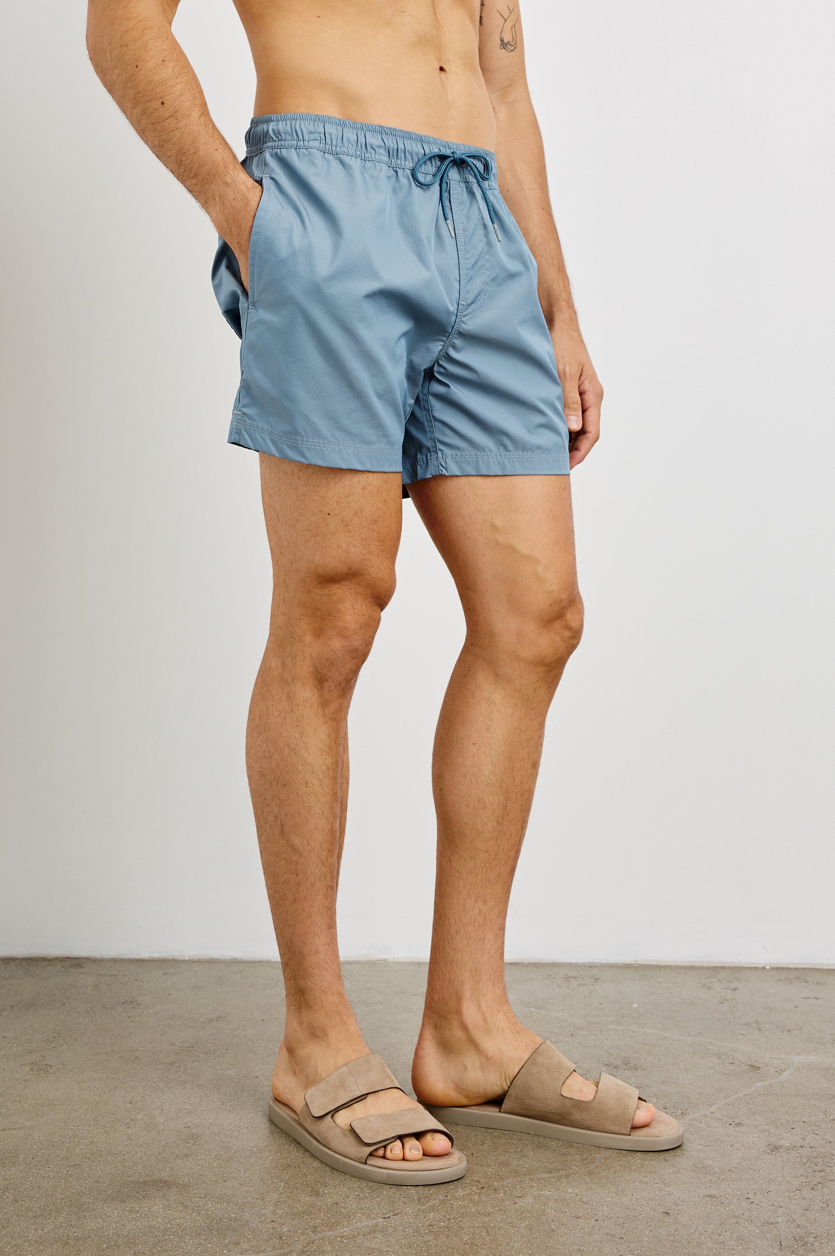 La Brea textured mid-length swim short with adjustable waist drawstring in Slate Blue - front view on model, slight angle